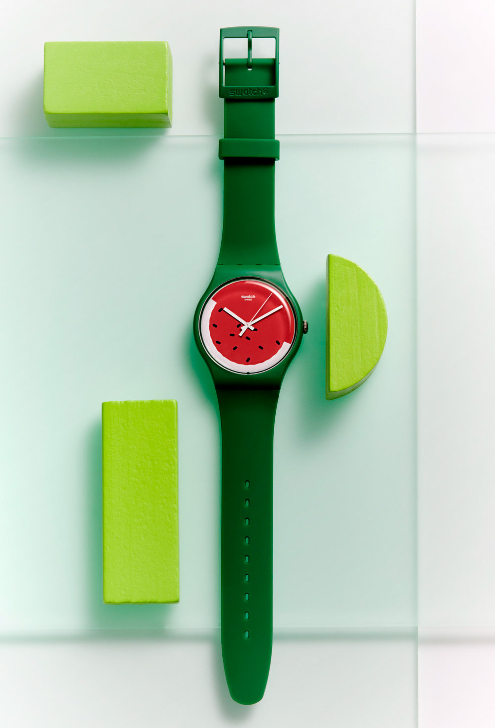 Green watermelon Swatch watch resting on layered perspex background. Still Life Photograph by London Based Still Life Photographer Andy Carson 