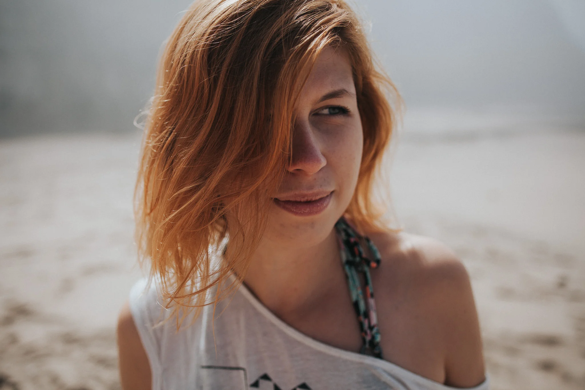 Portrait of a red-haired woman at the beach