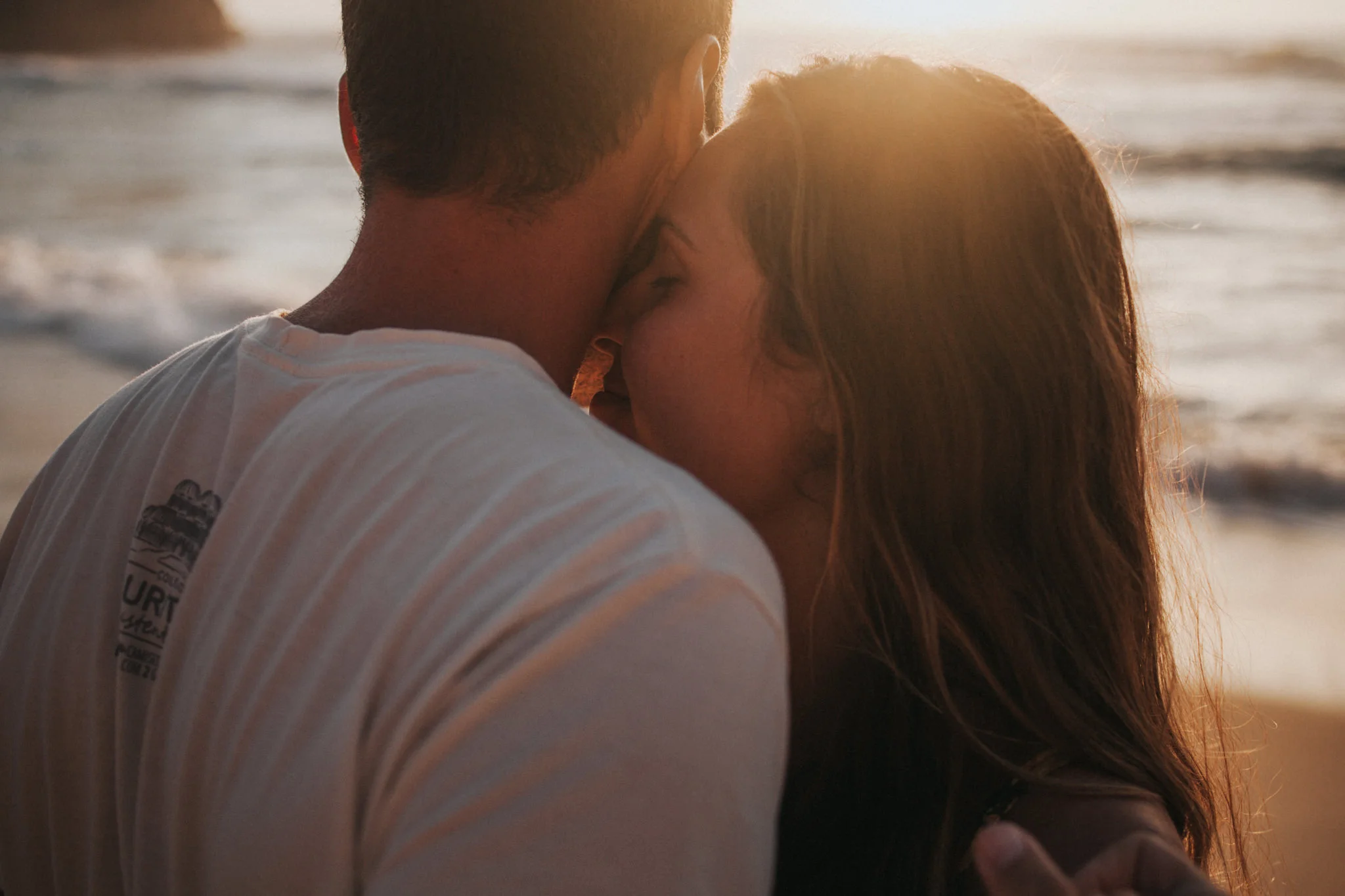 Bride kisses the grooms neck