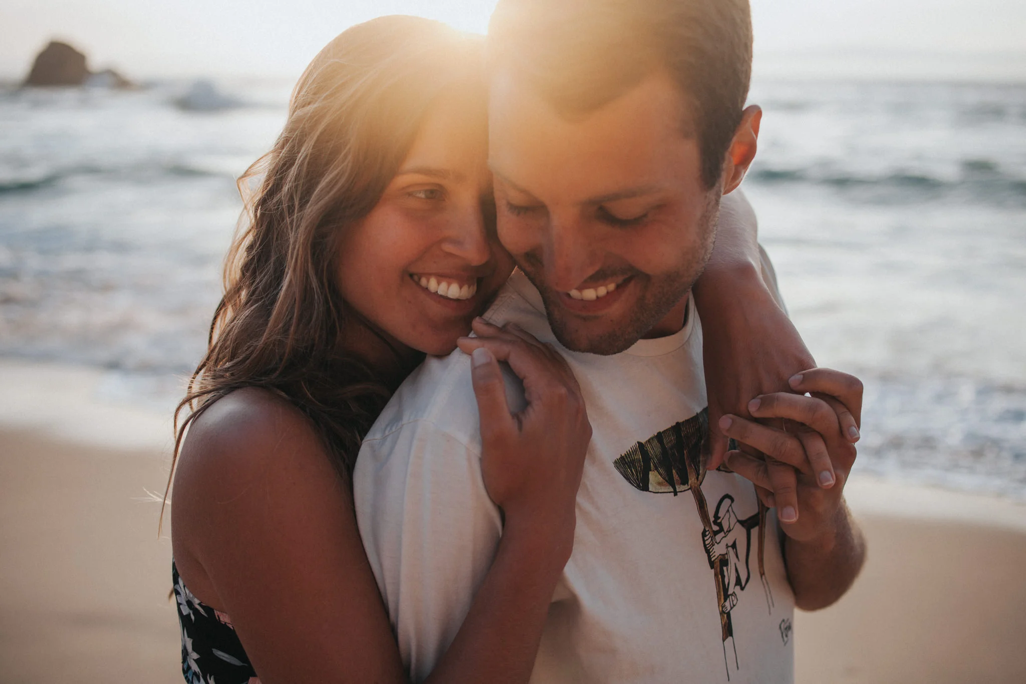 Bride and Groom smiling during the sunset at Praia da Ursa