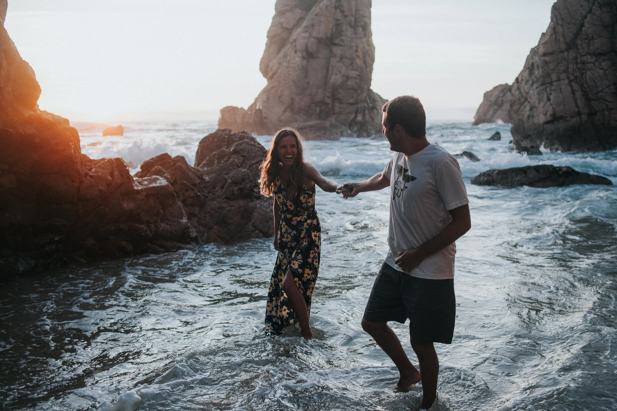 Bride and Groom standing in the cold water laughing