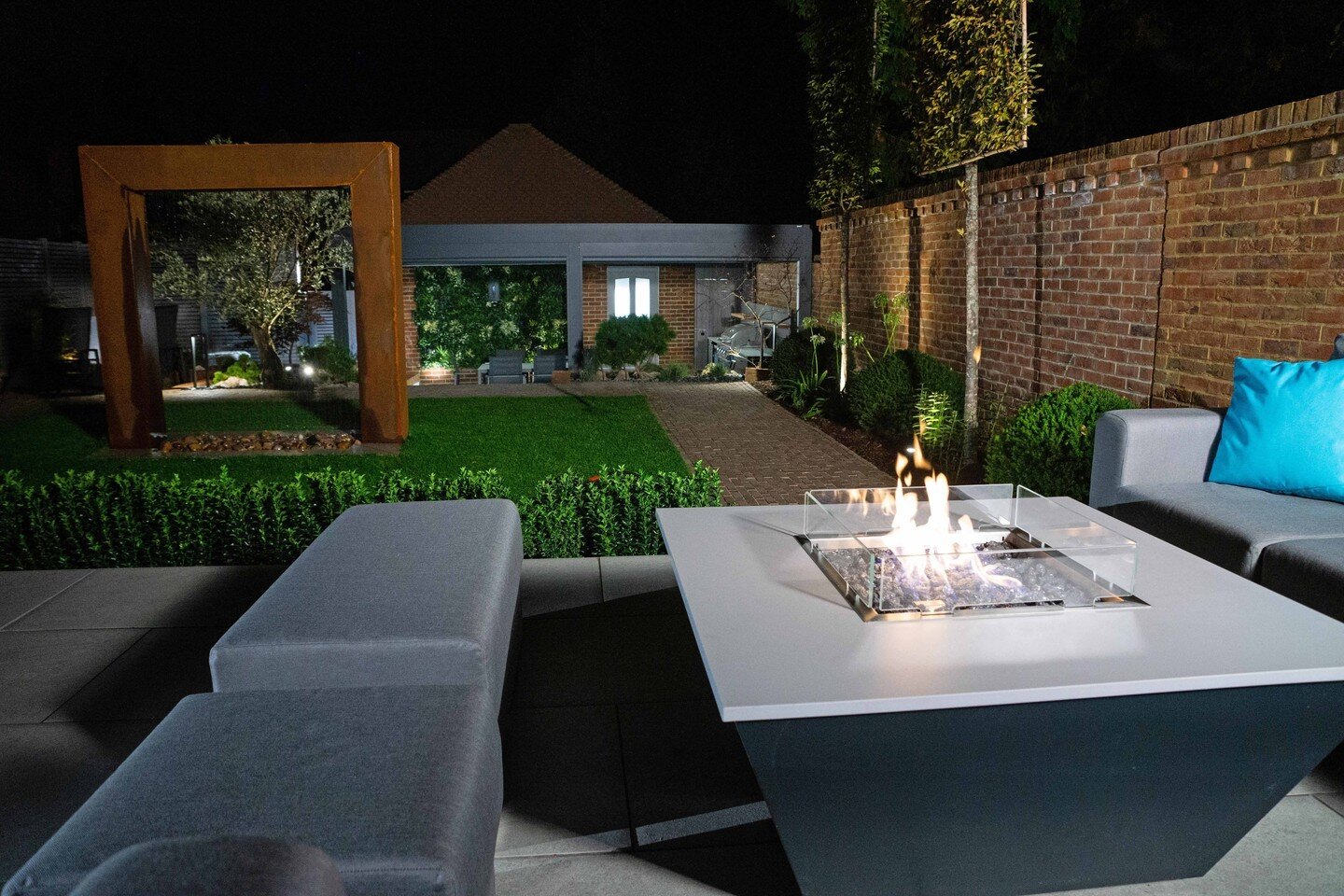 An evening shot from our latest project in Sevenoaks. Wow, check out that fire pit!! This garden truly has everything from fire pits to water features, hot tubs, Caribbean blinds, and even a robot lawn mower!

This garden really is an all-purpose gar