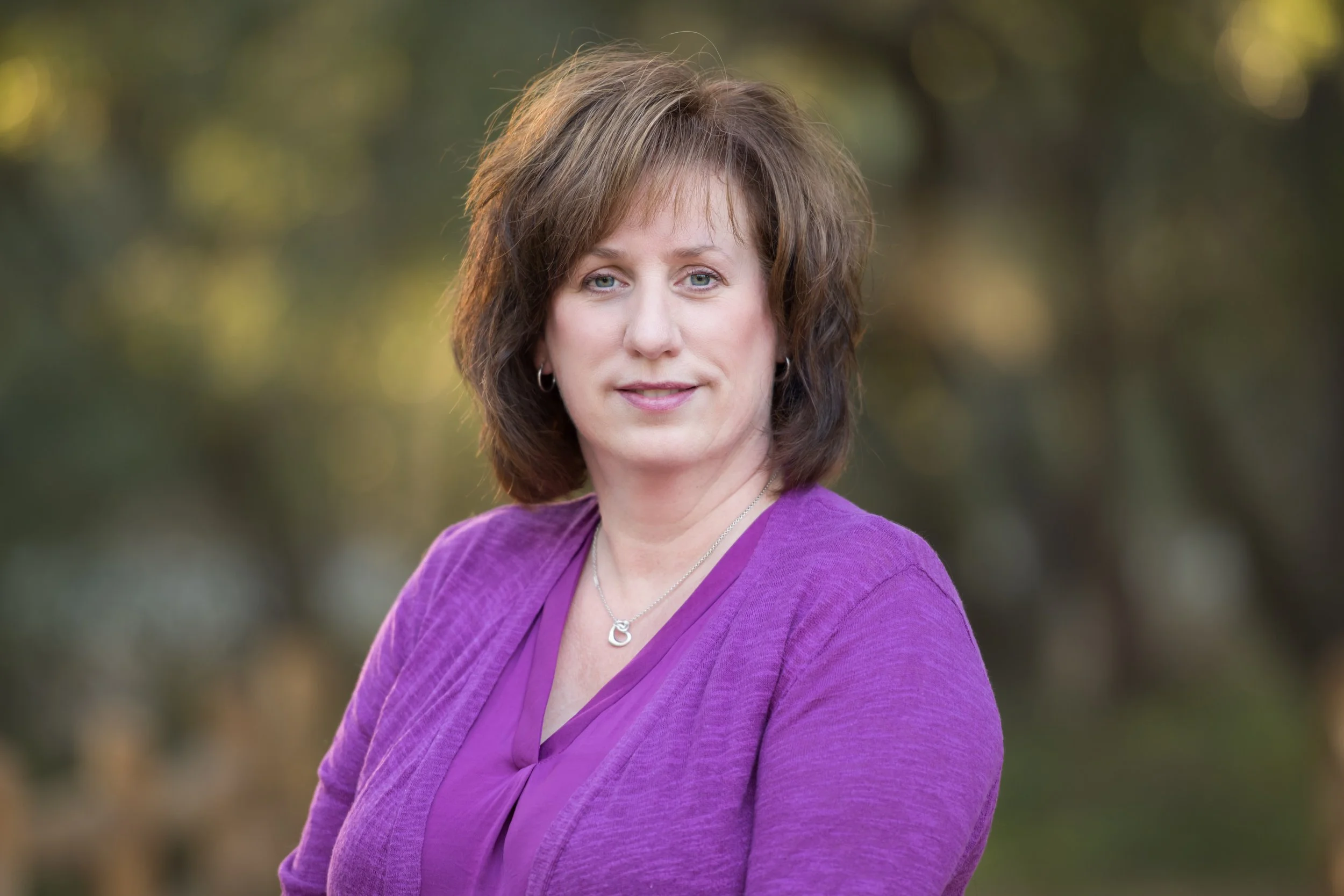 headshot of a woman in purple
