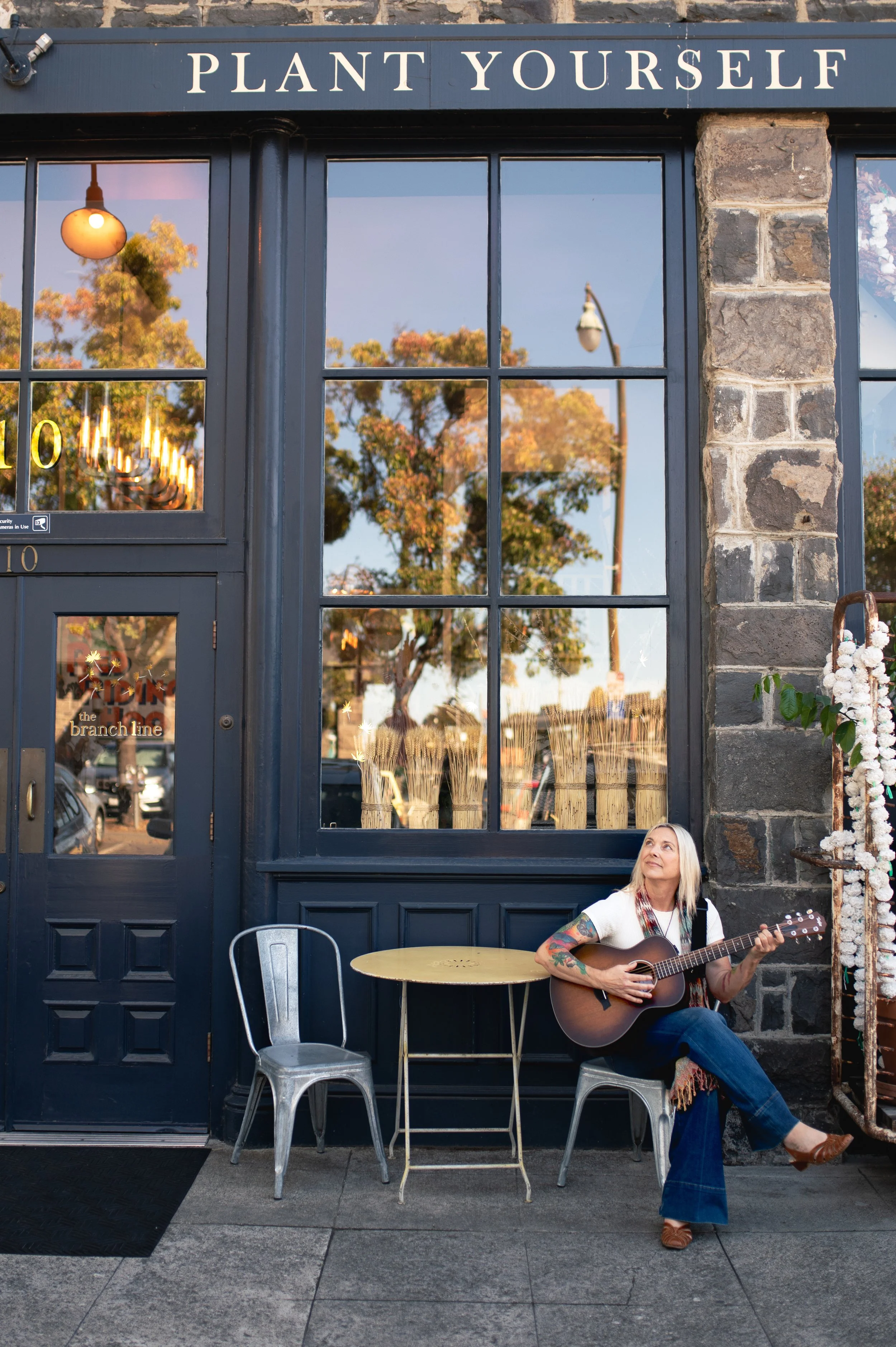 Woman playing guitar at a coffee shop