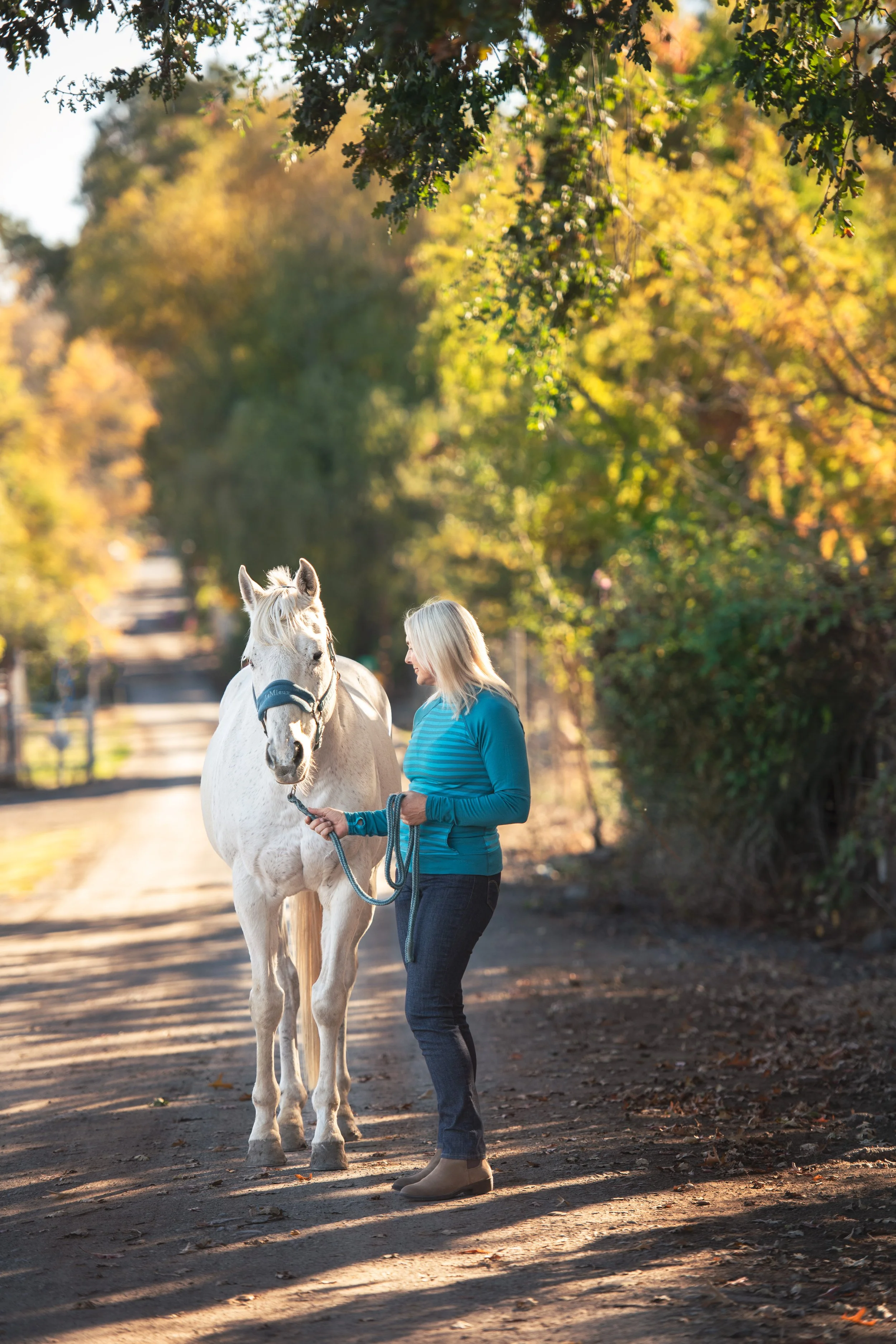 woman walking with horse