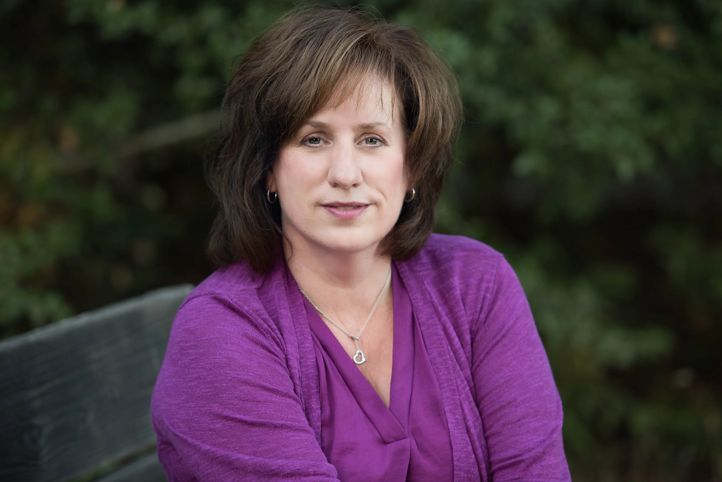 headshot of a woman in purple