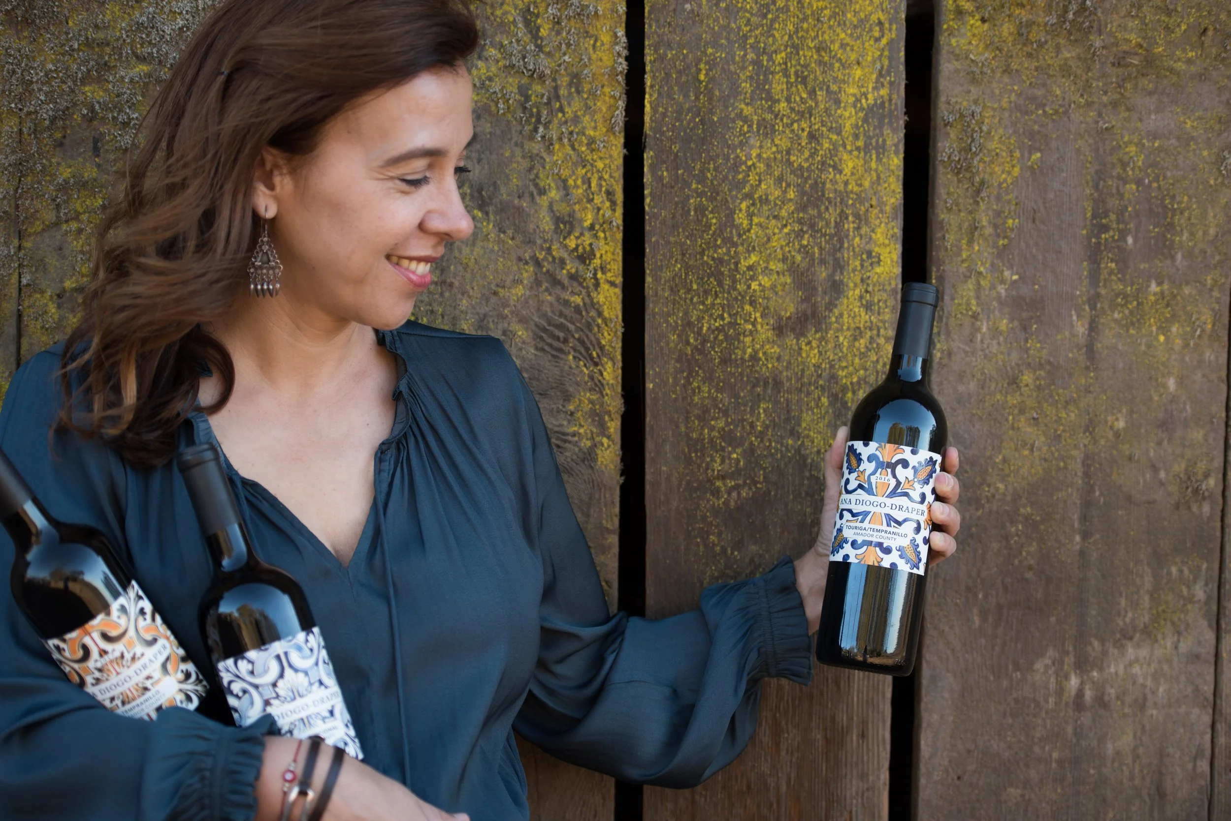 winemaker displaying her bottles