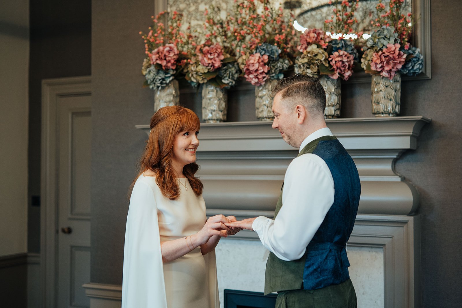 Bride and Groom exchanging rings in the Mayfair Room at Old Marylebone Town Hall