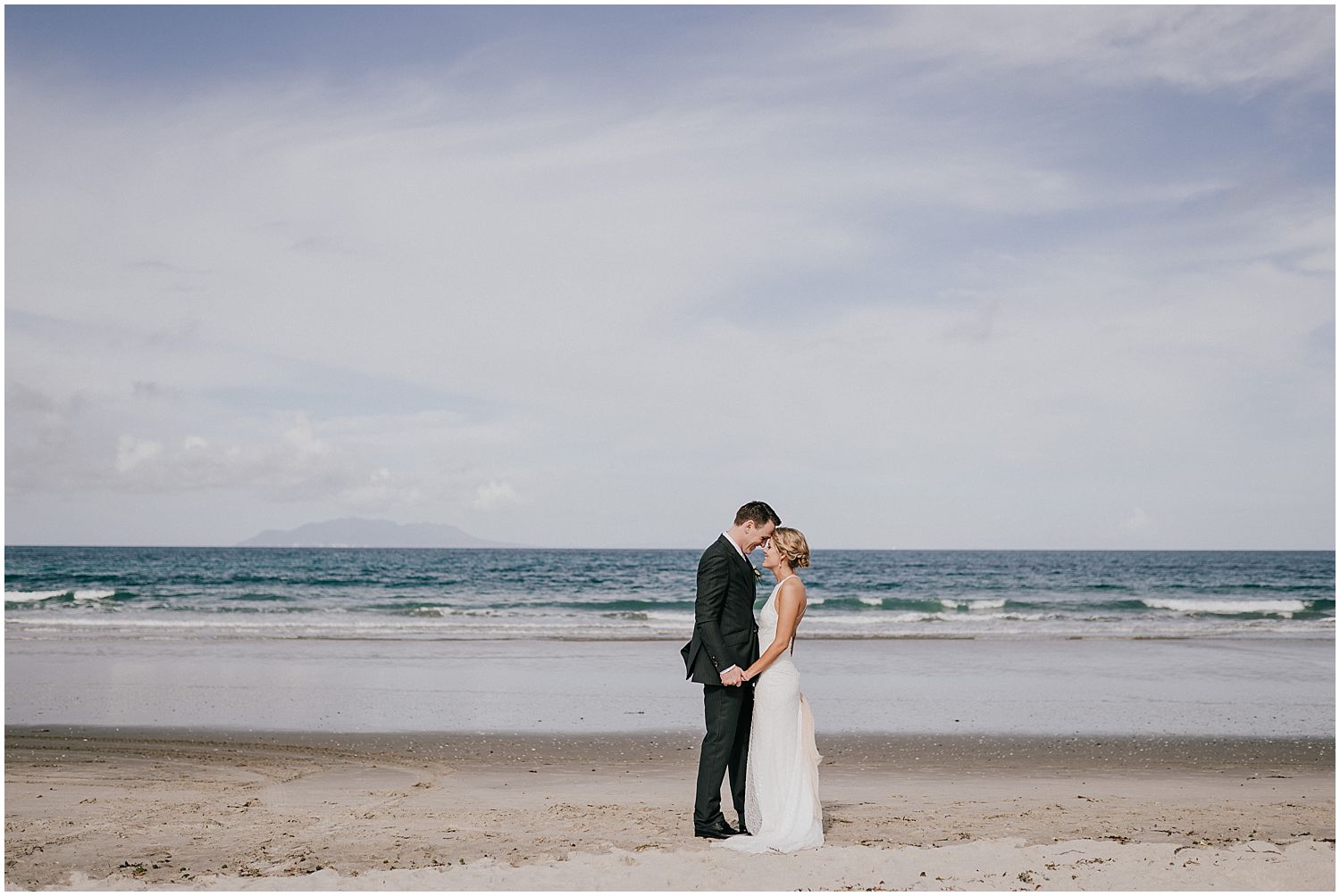 Wedding photo of bride and groom on Omaha beach