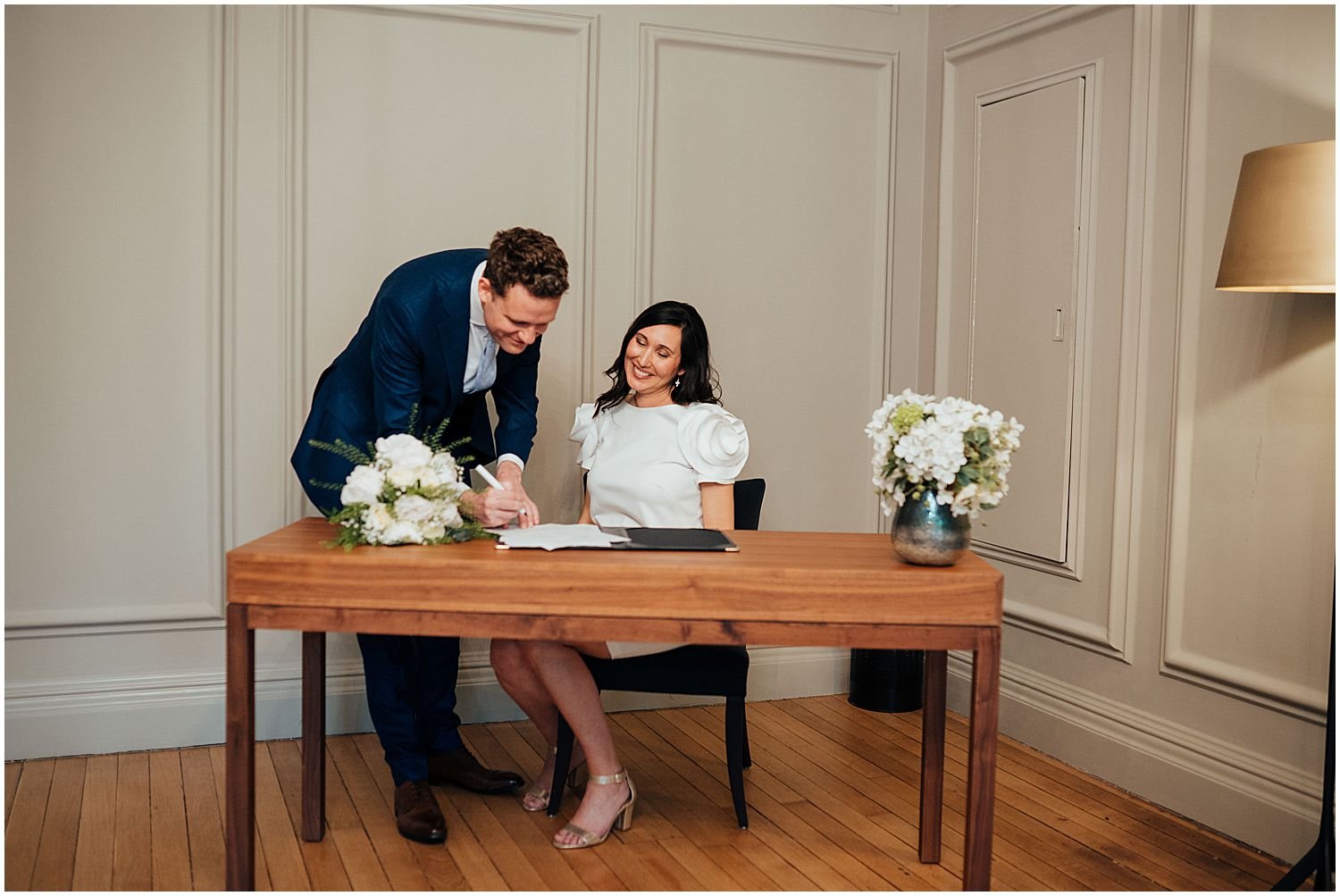 Bride and groom signing wedding register at Marylebone Town Hall