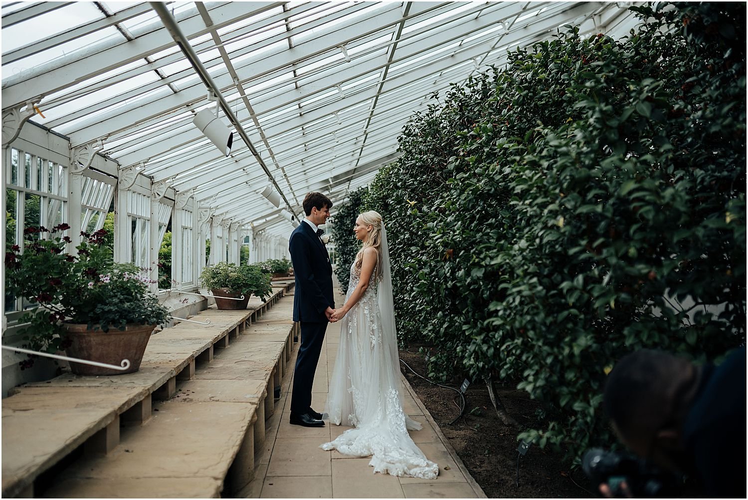 Bride and groom in conservatory at Chiswick House and Gardens