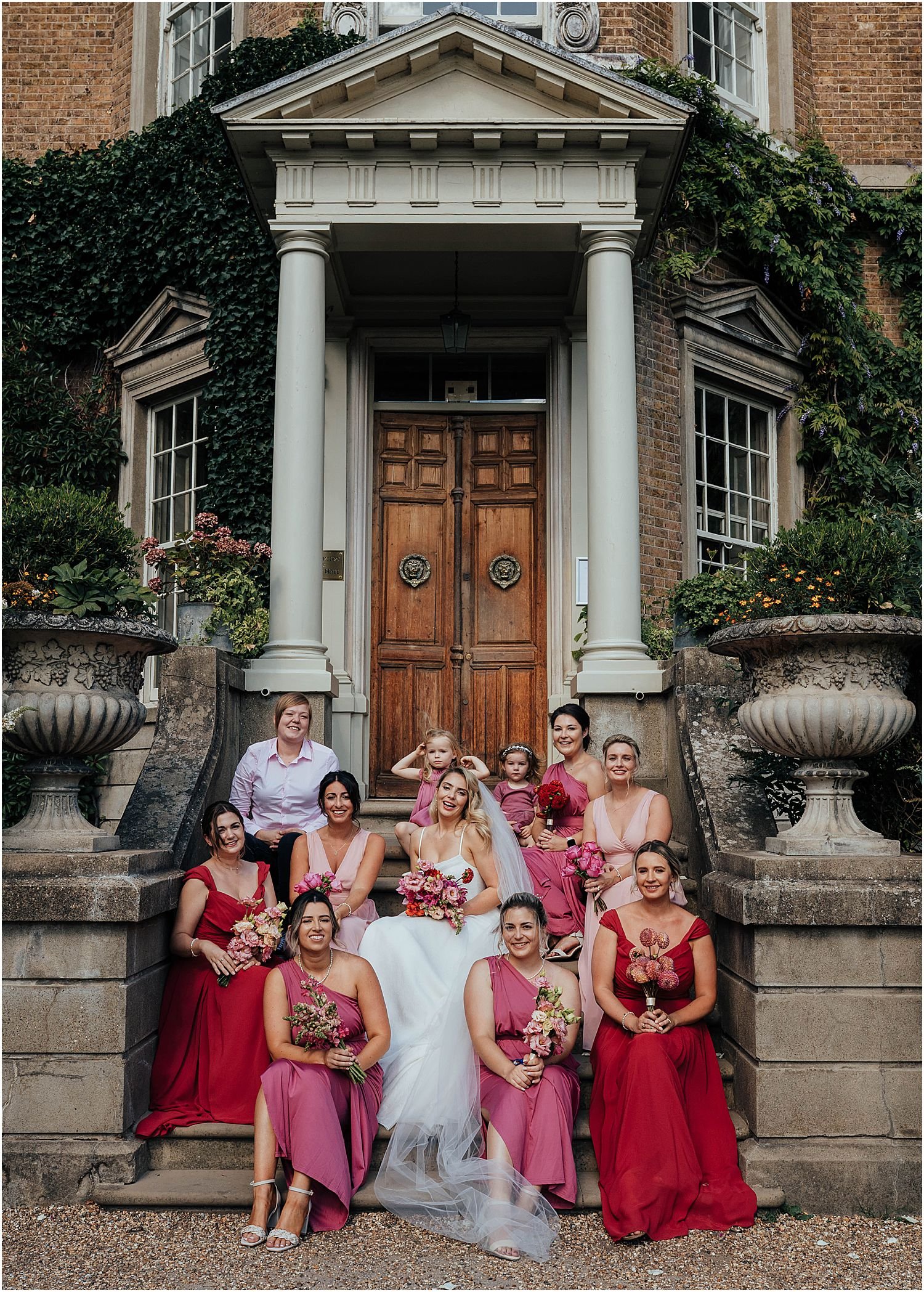 Bridesmaids on steps outside Hampton Court House