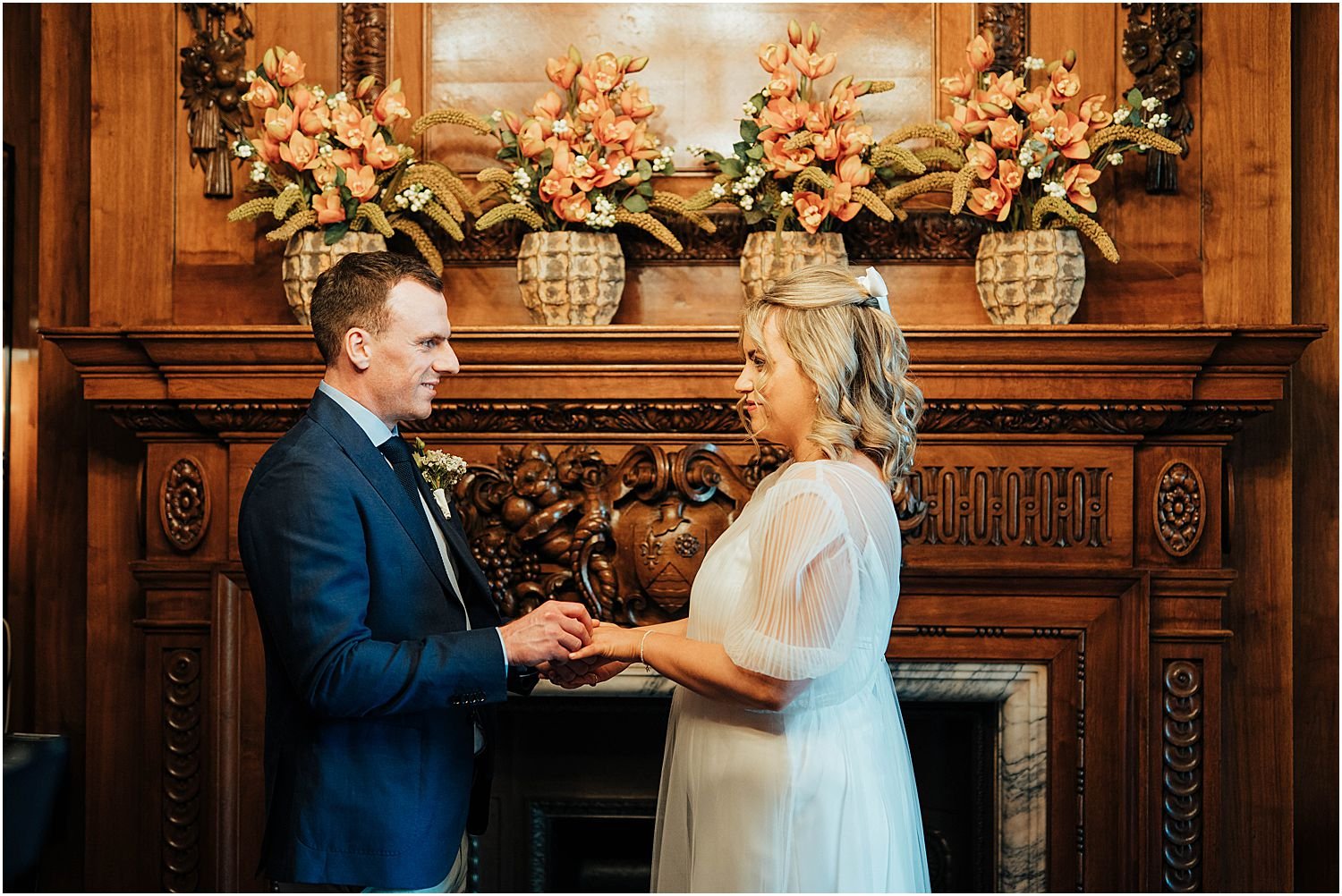 Bride and groom exchanging rings in Paddington Room at Old Marylebone Town Hall