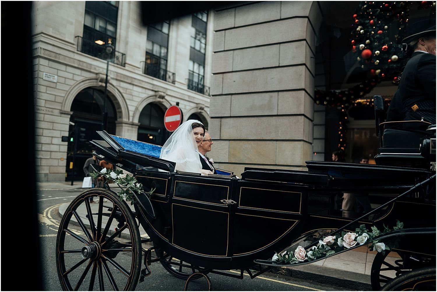 Bride in horse and carriage outside the Ritz in London 
