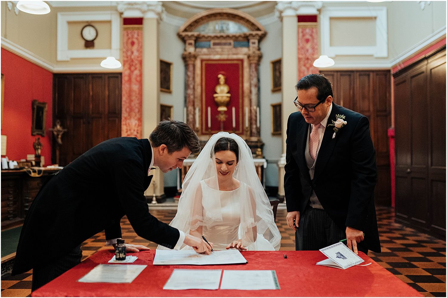 Bride and groom signing wedding register