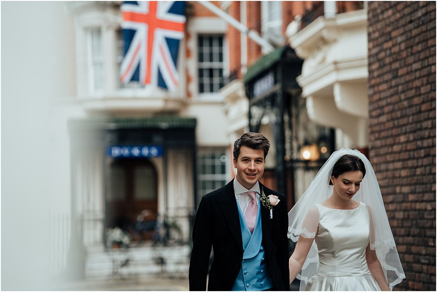 Bride and groom walking on streets in Mayfair