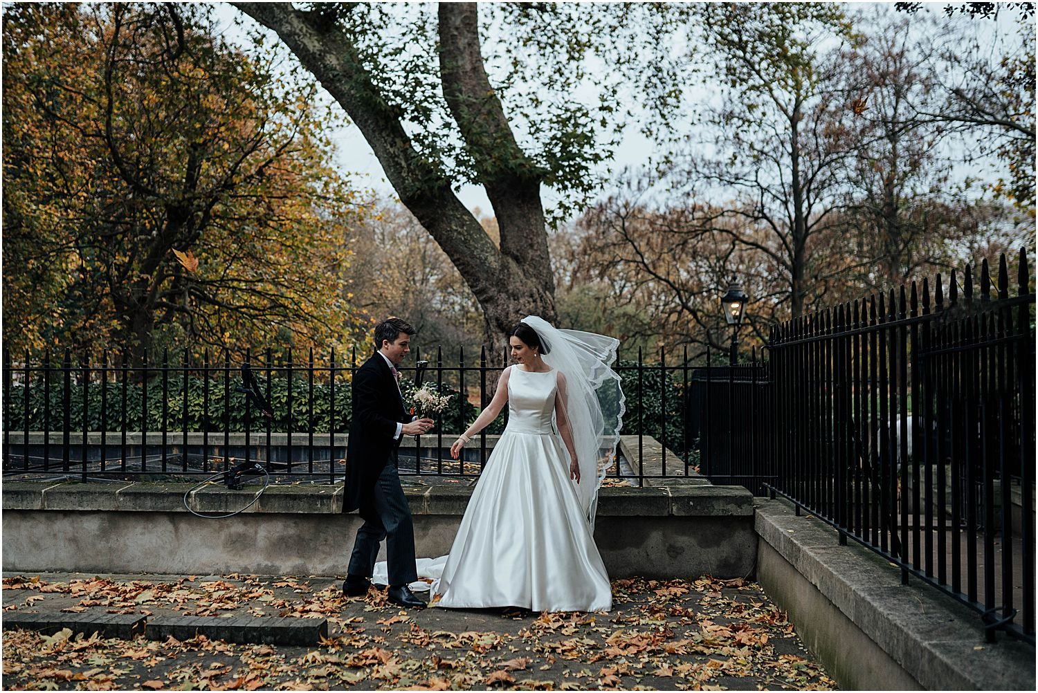 Bride and groom with autumn leaves in Mayfair