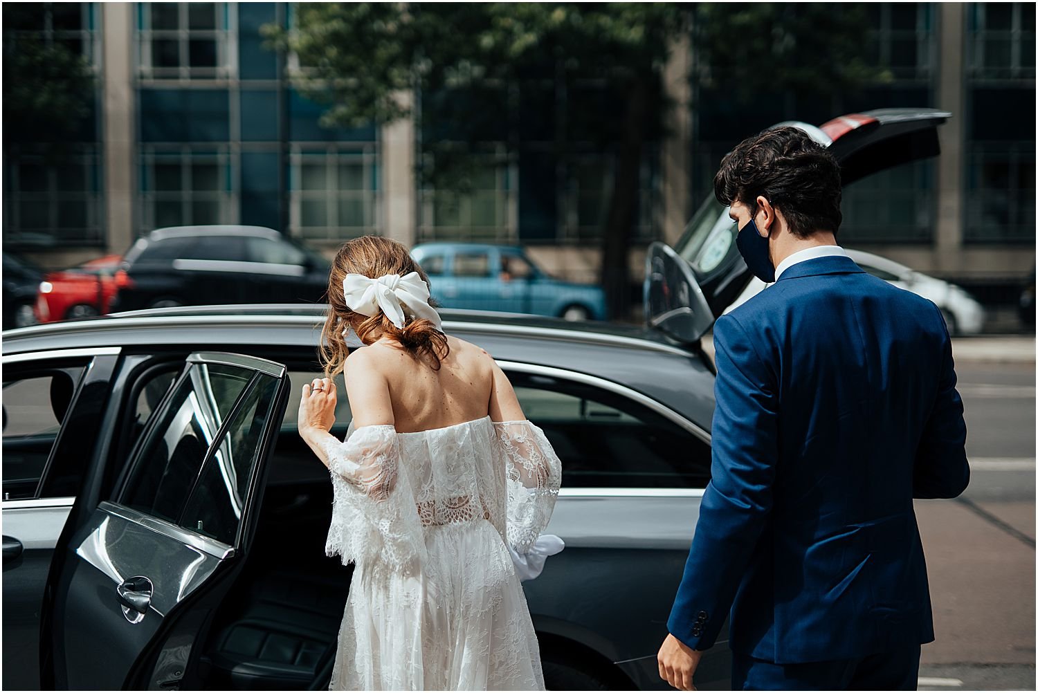 Bride and groom getting in car