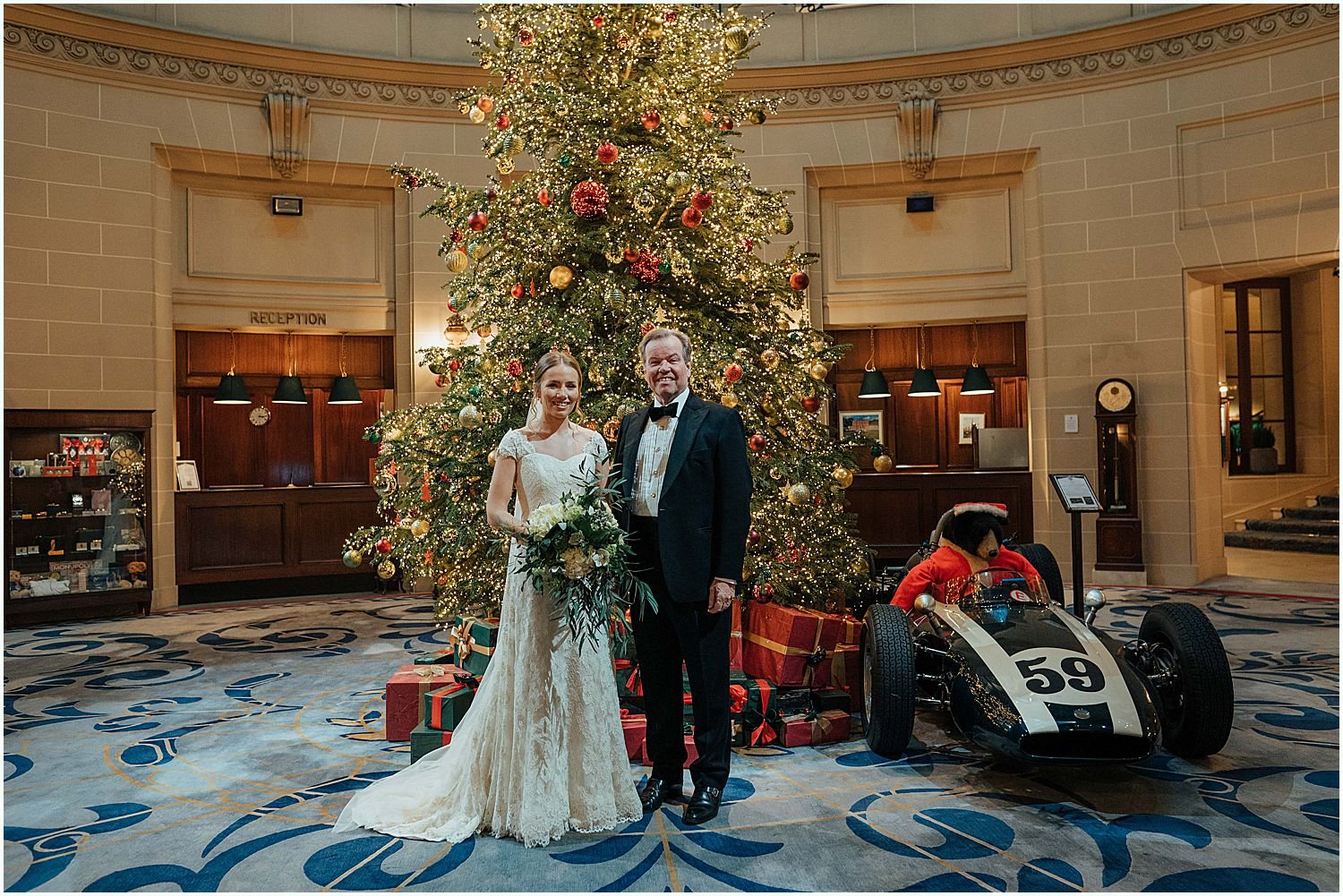Bride and father in front of Christmas tree at RAC wedding