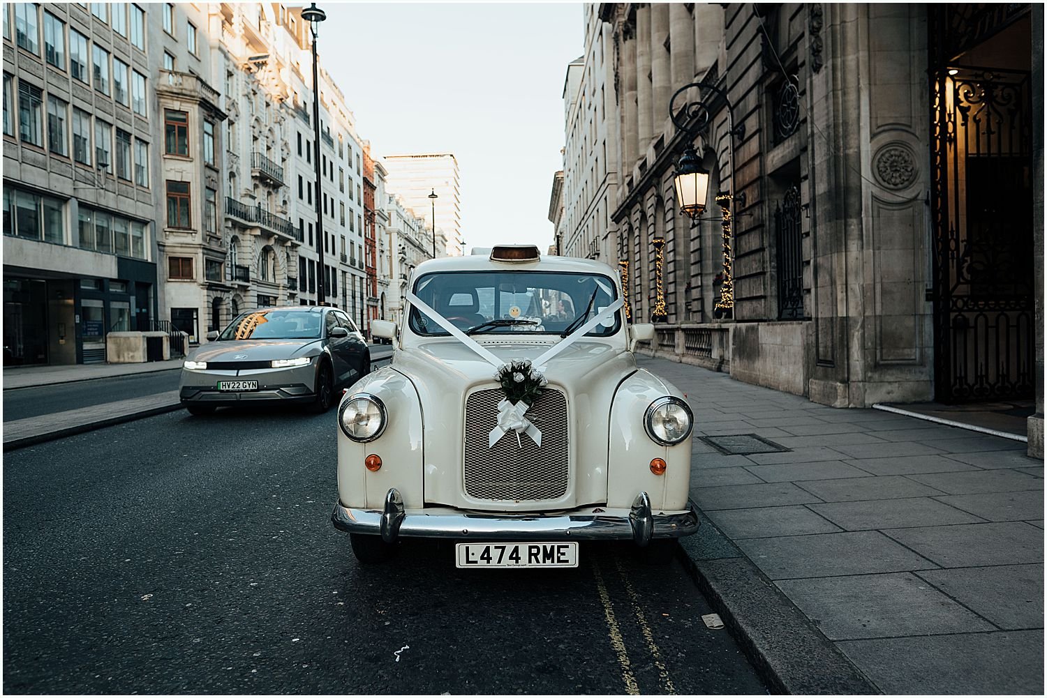 Vintage London white wedding taxi outside Royal Automobile Club