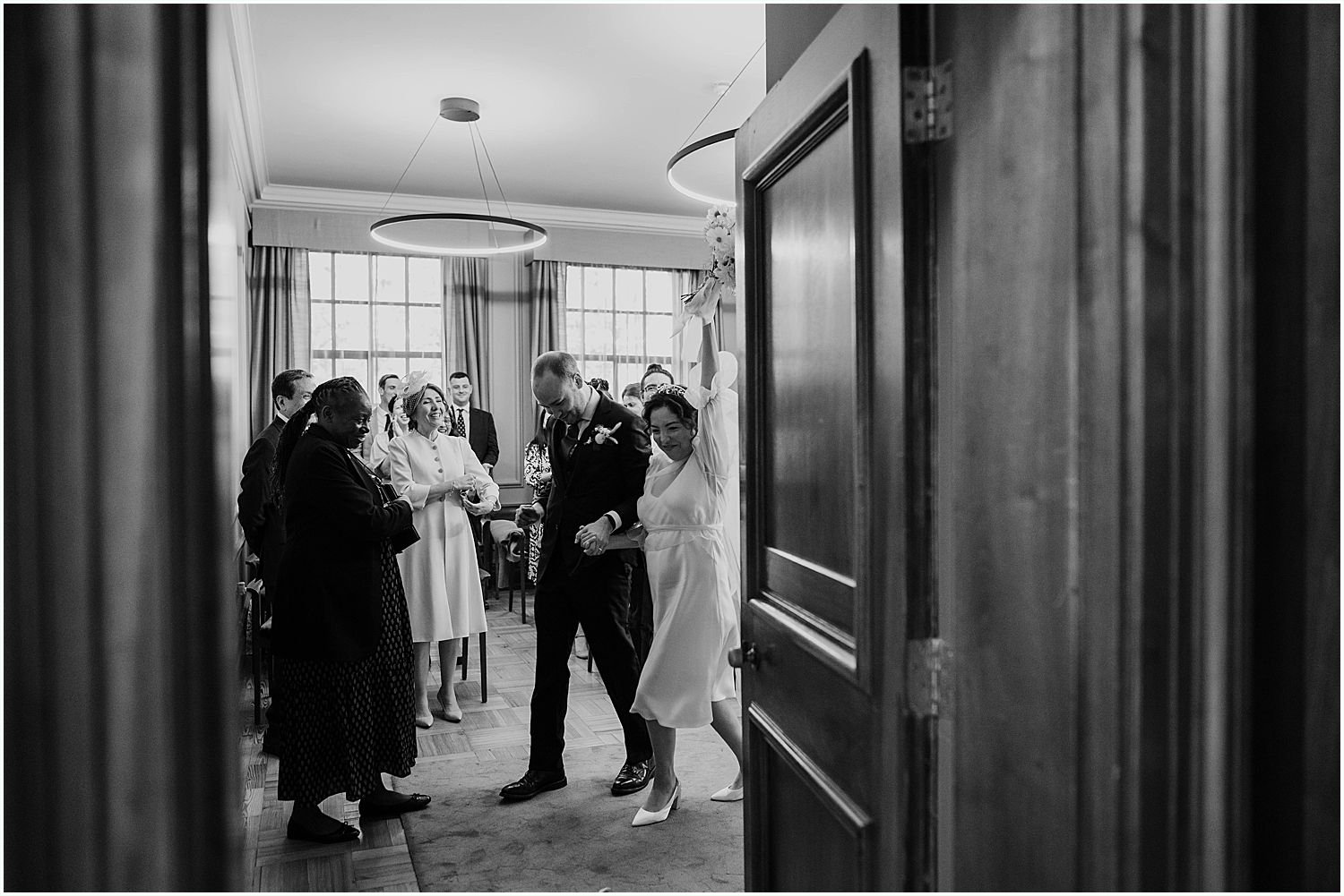 Bride and groom exiting Knightsbride room after their wedding ceremony 