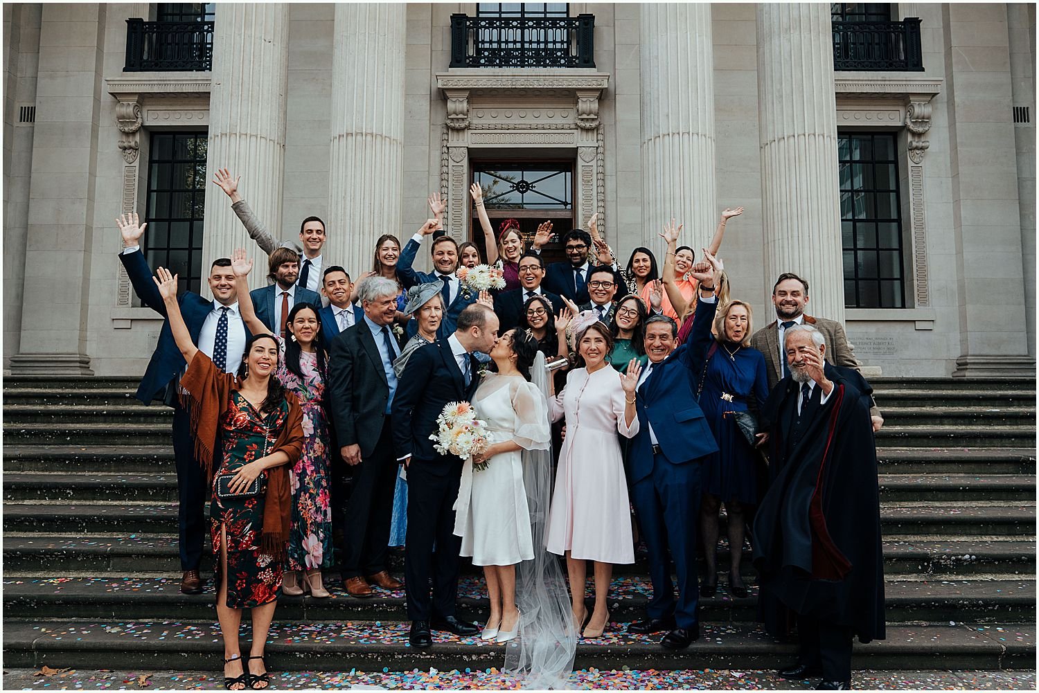 Group photo of all guests on steps at the Old Marylebone Town Hall
