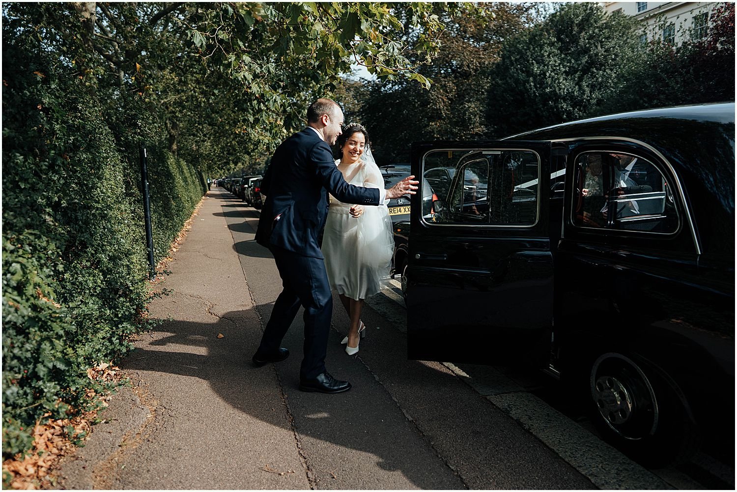 Julia and Alec with their vintage London black cab. 