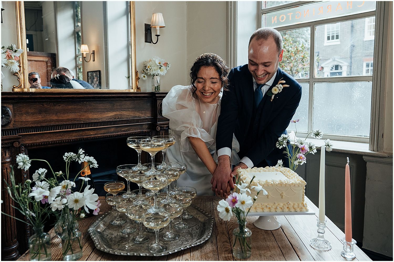 Wedding cake cutting on Julia and Alec's Old Marylebone Town Hall wedding day