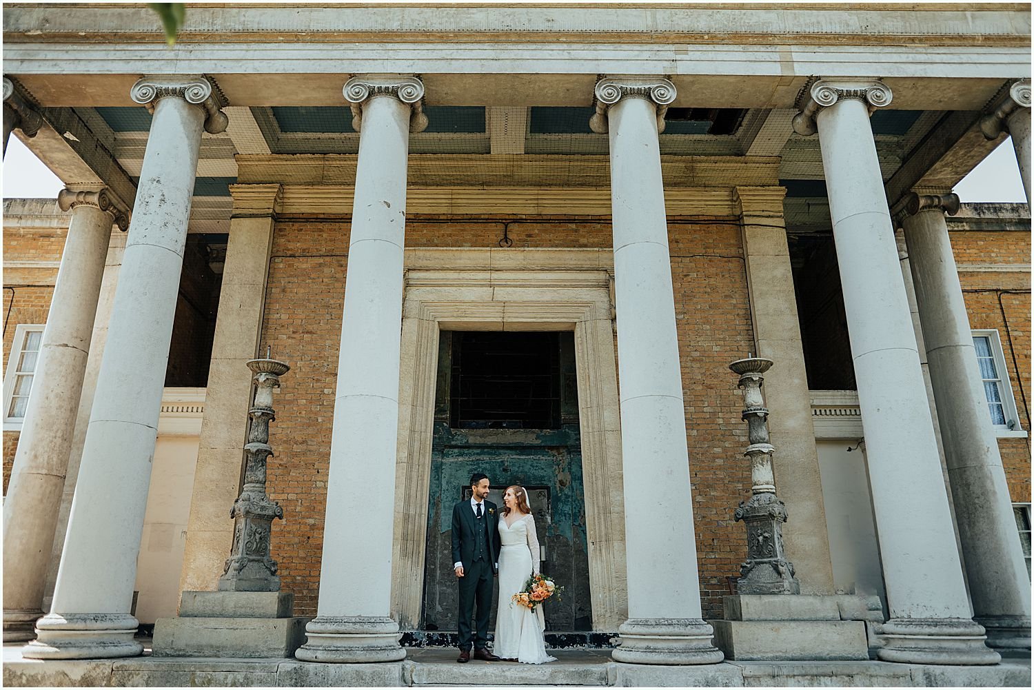 Bride and groom standing outside Asylum Chapel