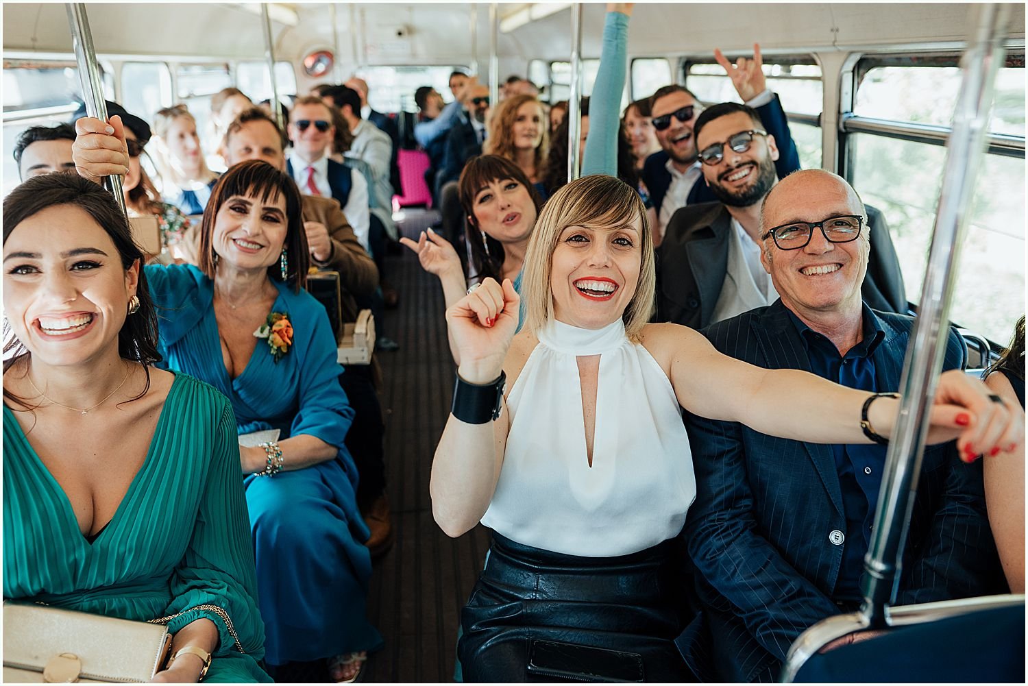 Guests having a party on a vintage London wedding bus