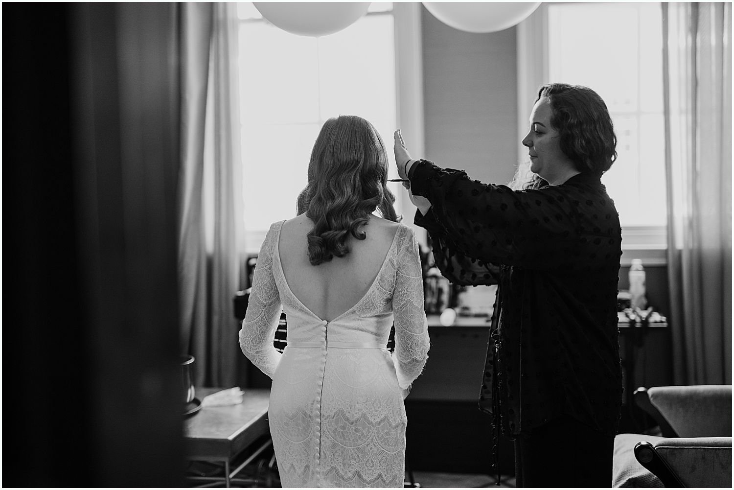 Black and white wedding photo of bride getting ready
