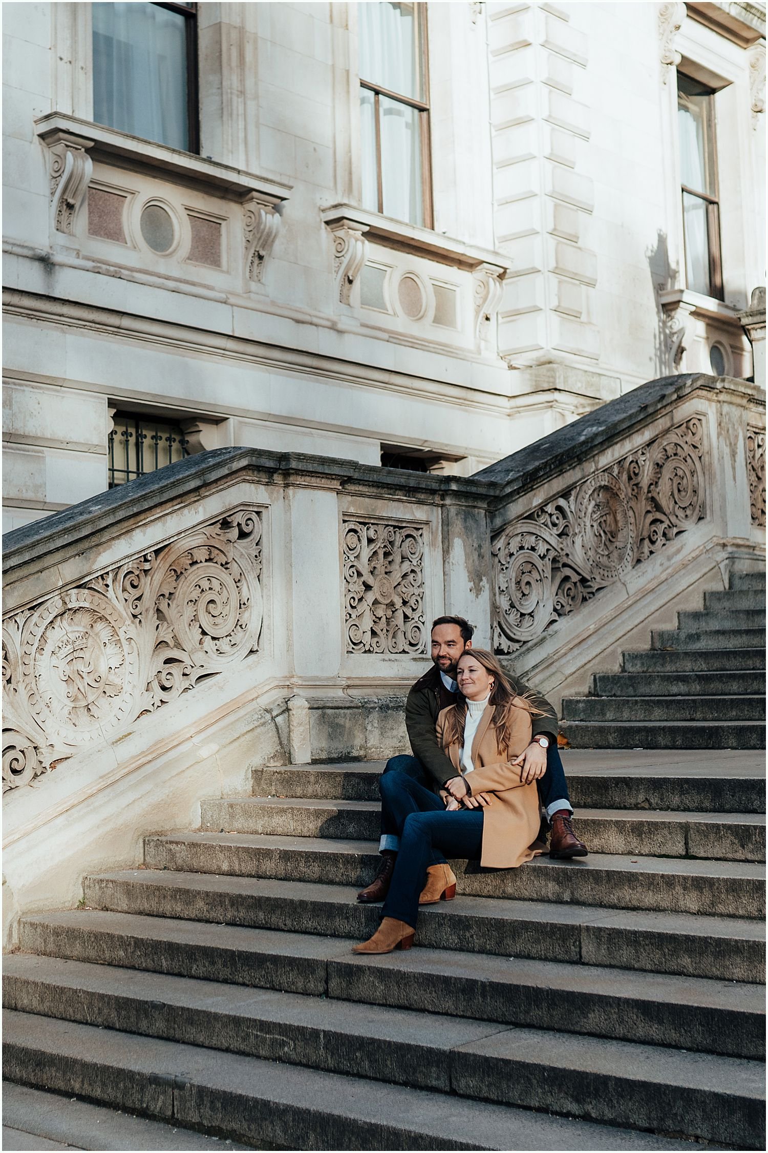 Couple sitting on steps in Westminster during photo shoot