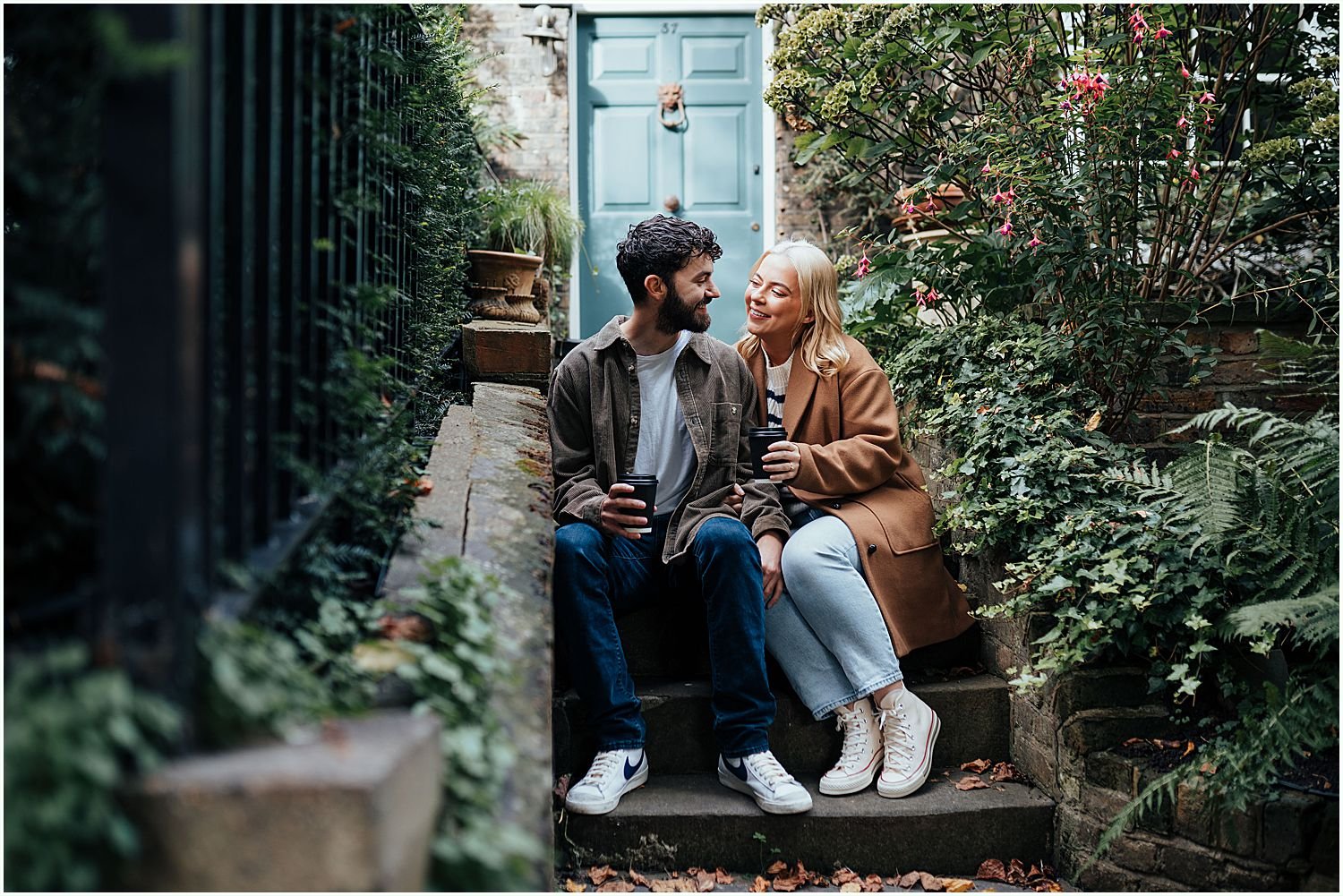 Engagement shoot - couple having coffee on steps