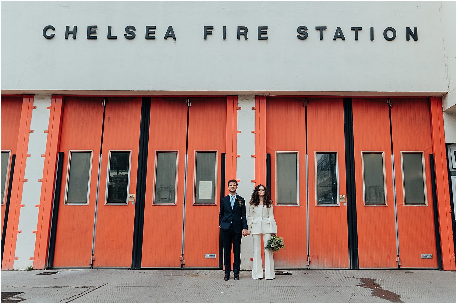 Bride and groom outside Chelsea Fire Station