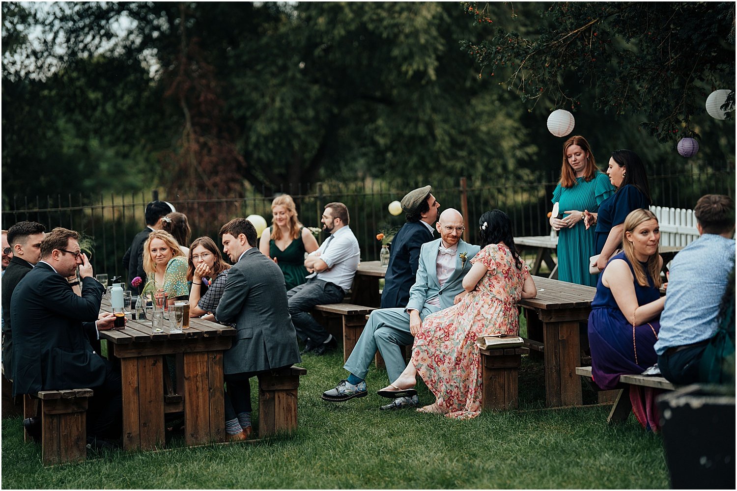 Candid photo of wedding guests mingling at Isis River Farmhouse