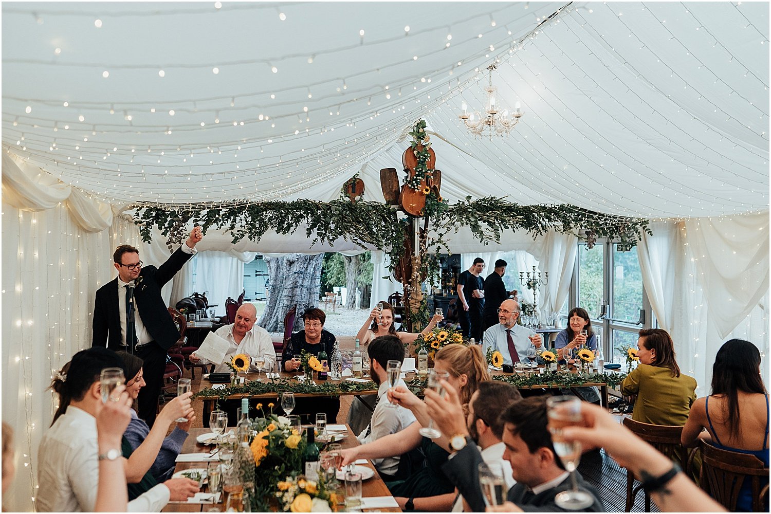 Wedding guests toasting groom