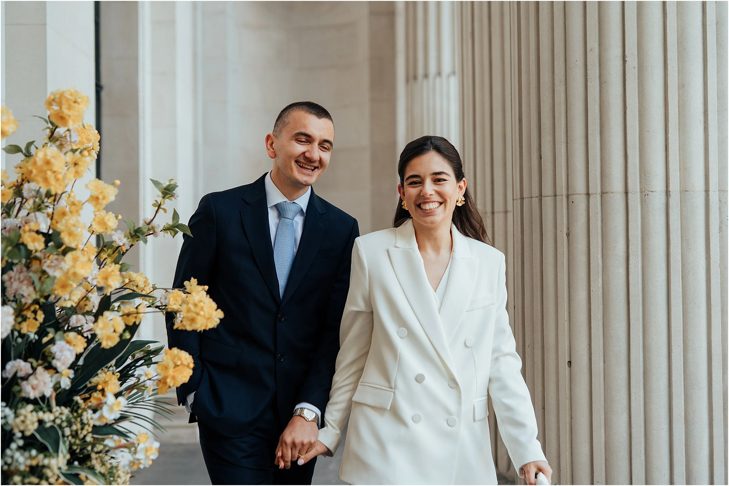 Newlyweds with columns at Old Marylebone Town Hall