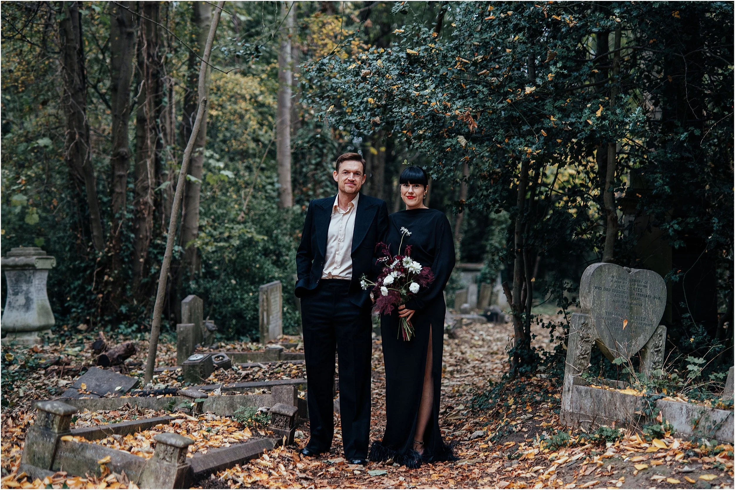 Goth bride and groom in front of graves London