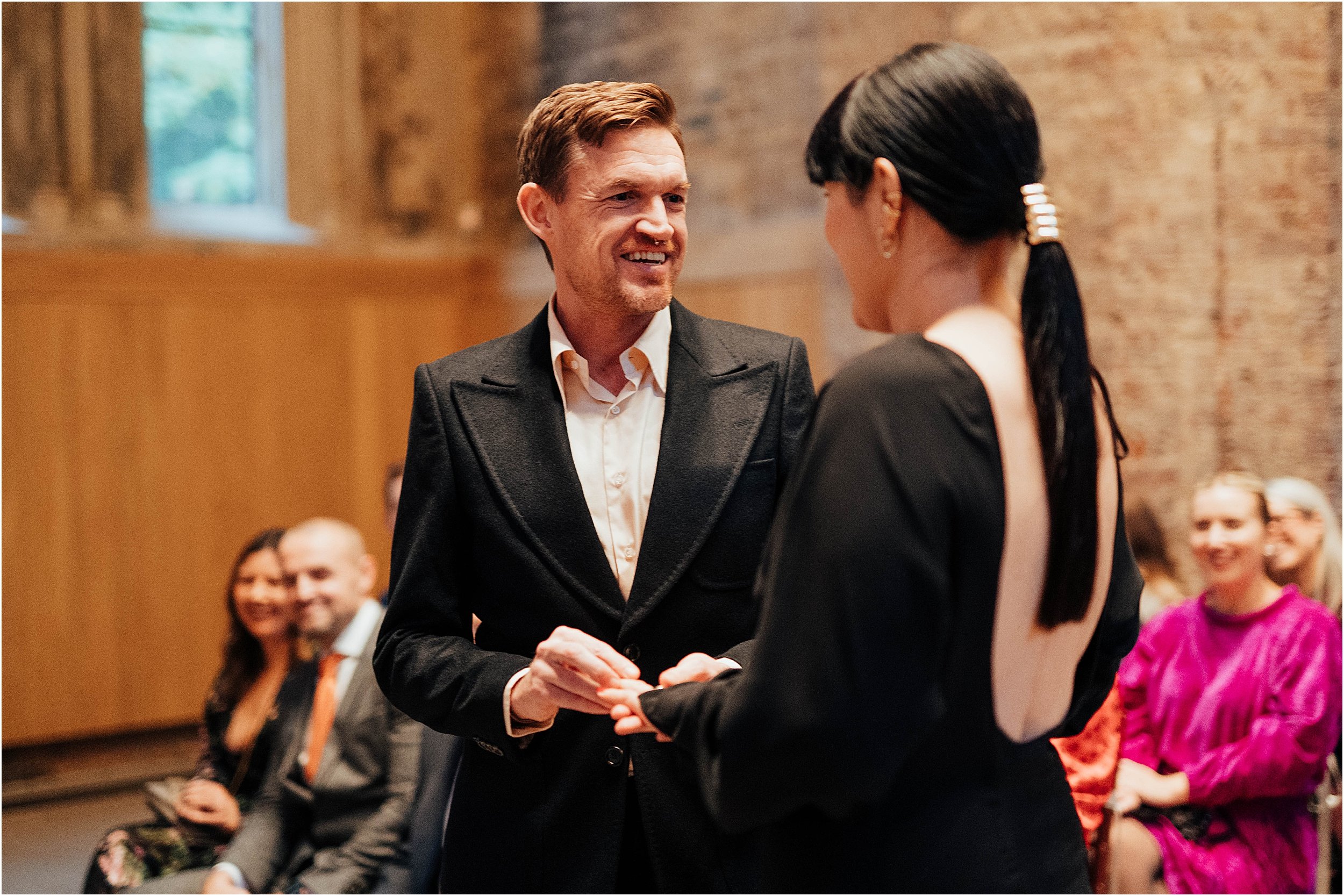 Groom giving wedding ring to bride