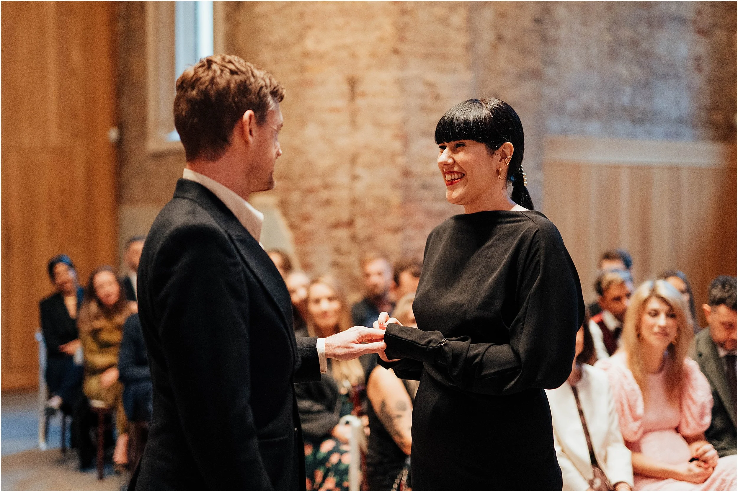 Bride giving ring to groom