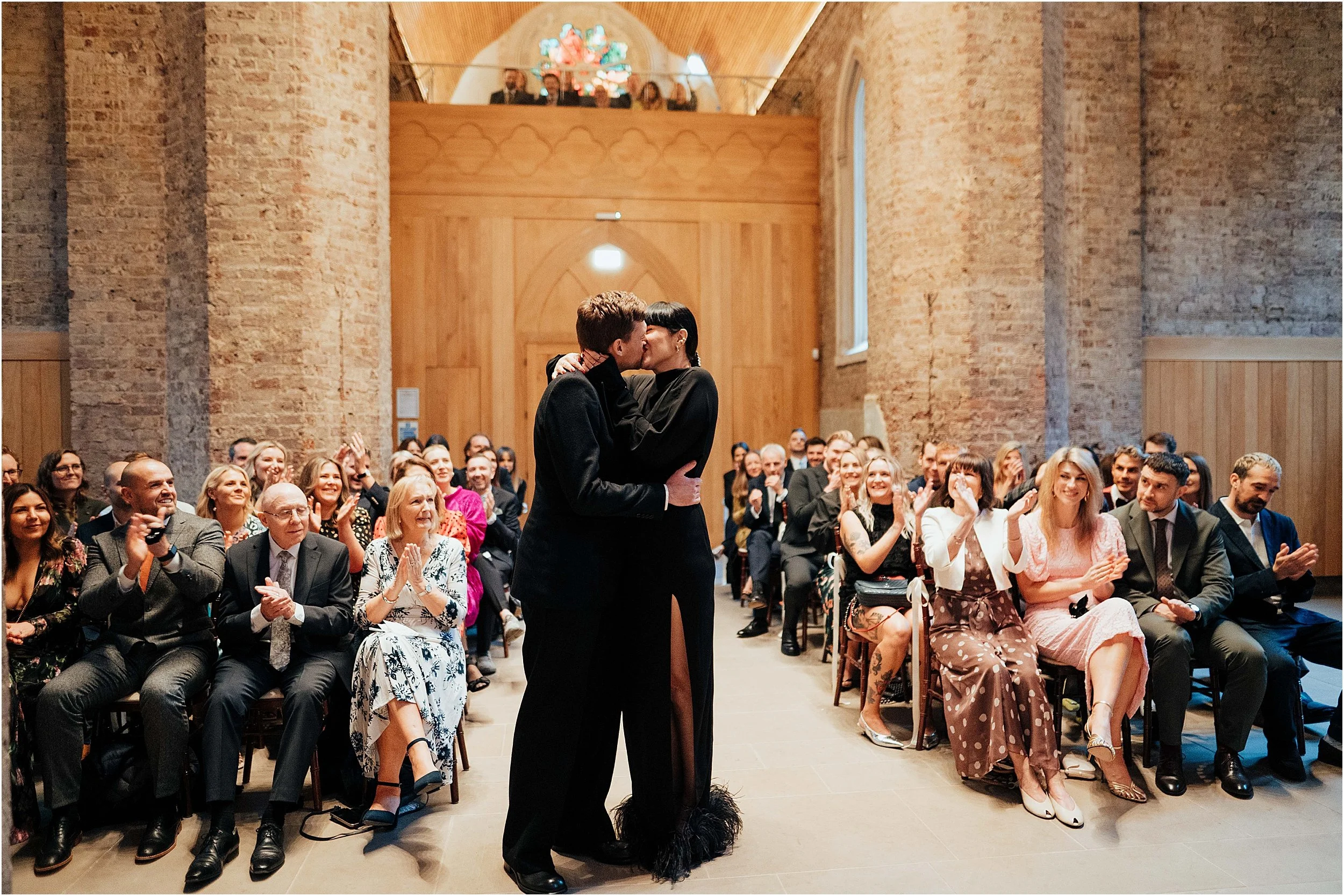 Bride and groom first kiss in chapel