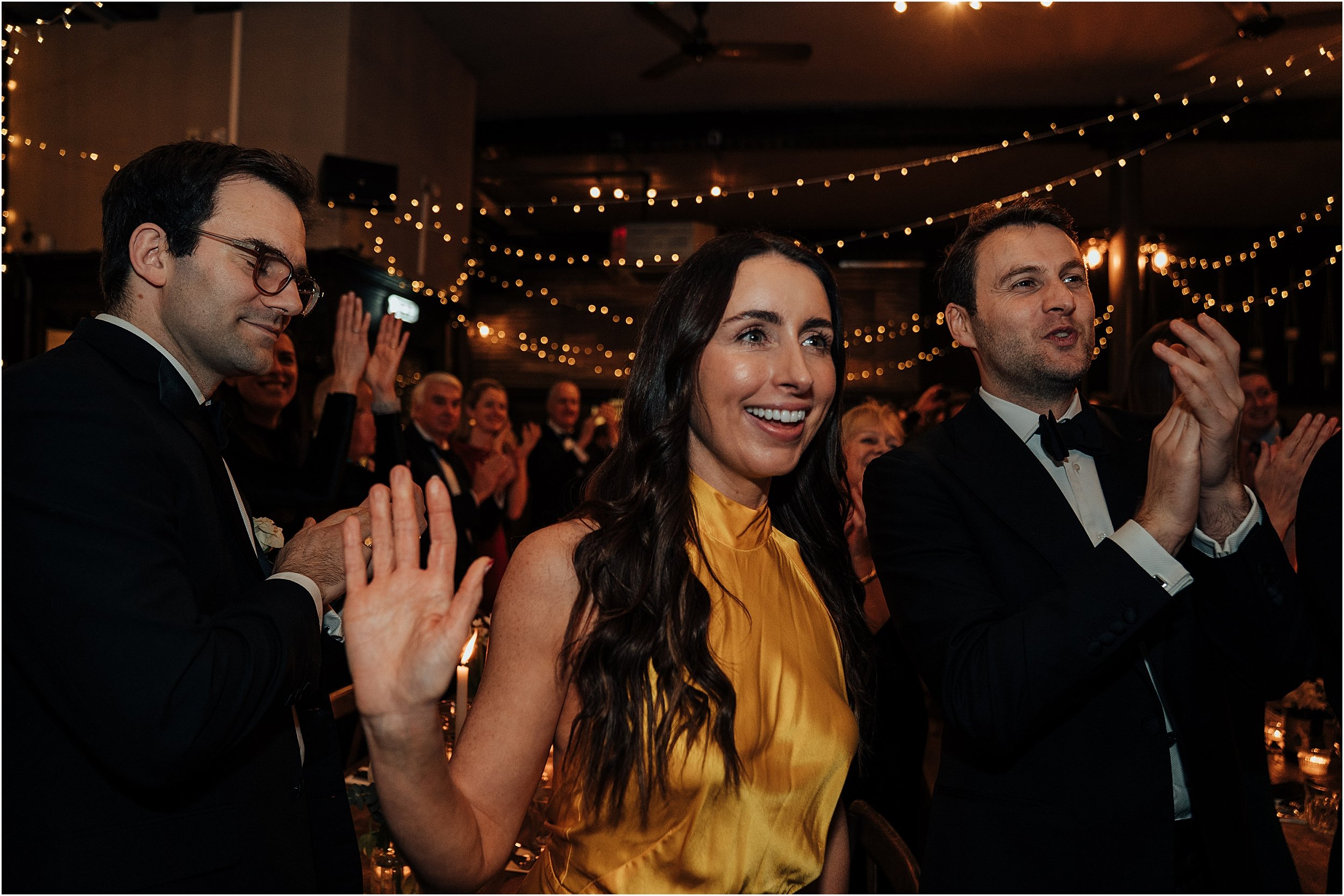 Wedding guests cheering on couple