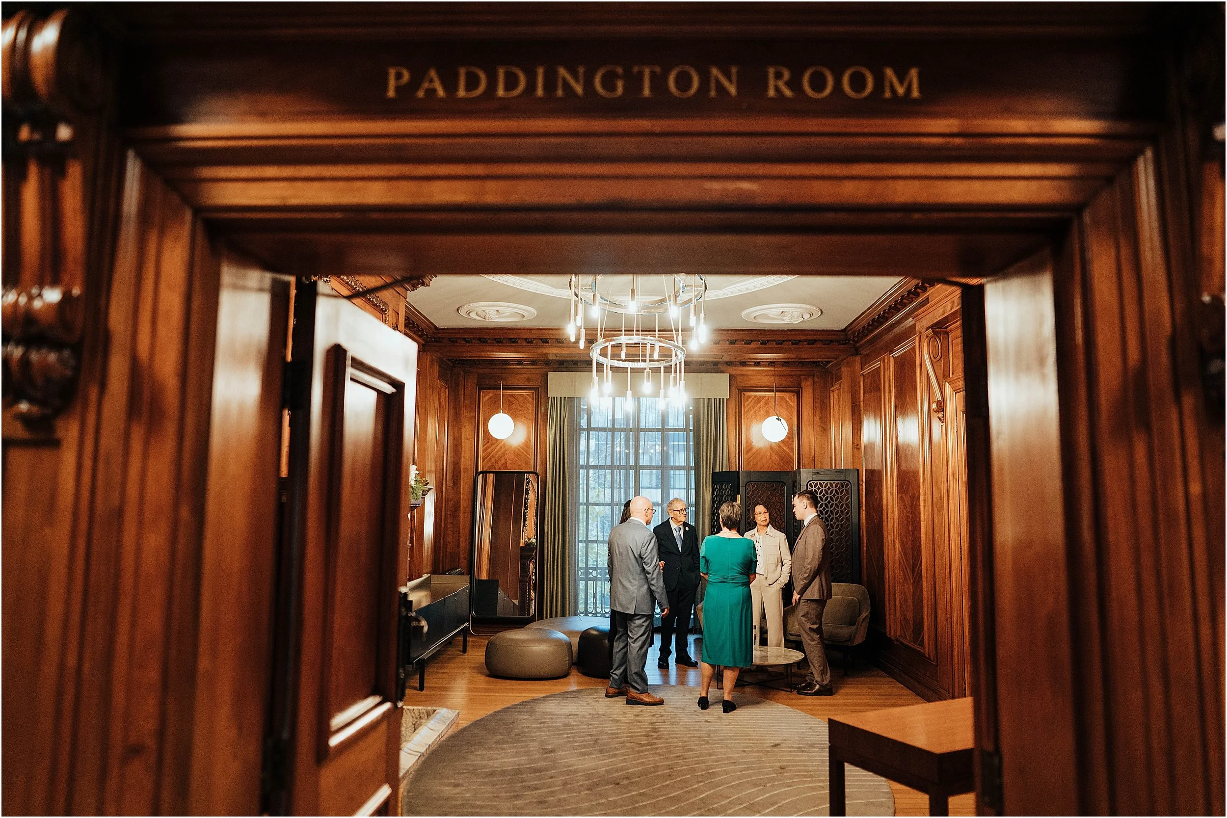 Wedding guests chatting in Paddington Room at Old Marylebone Town Hall