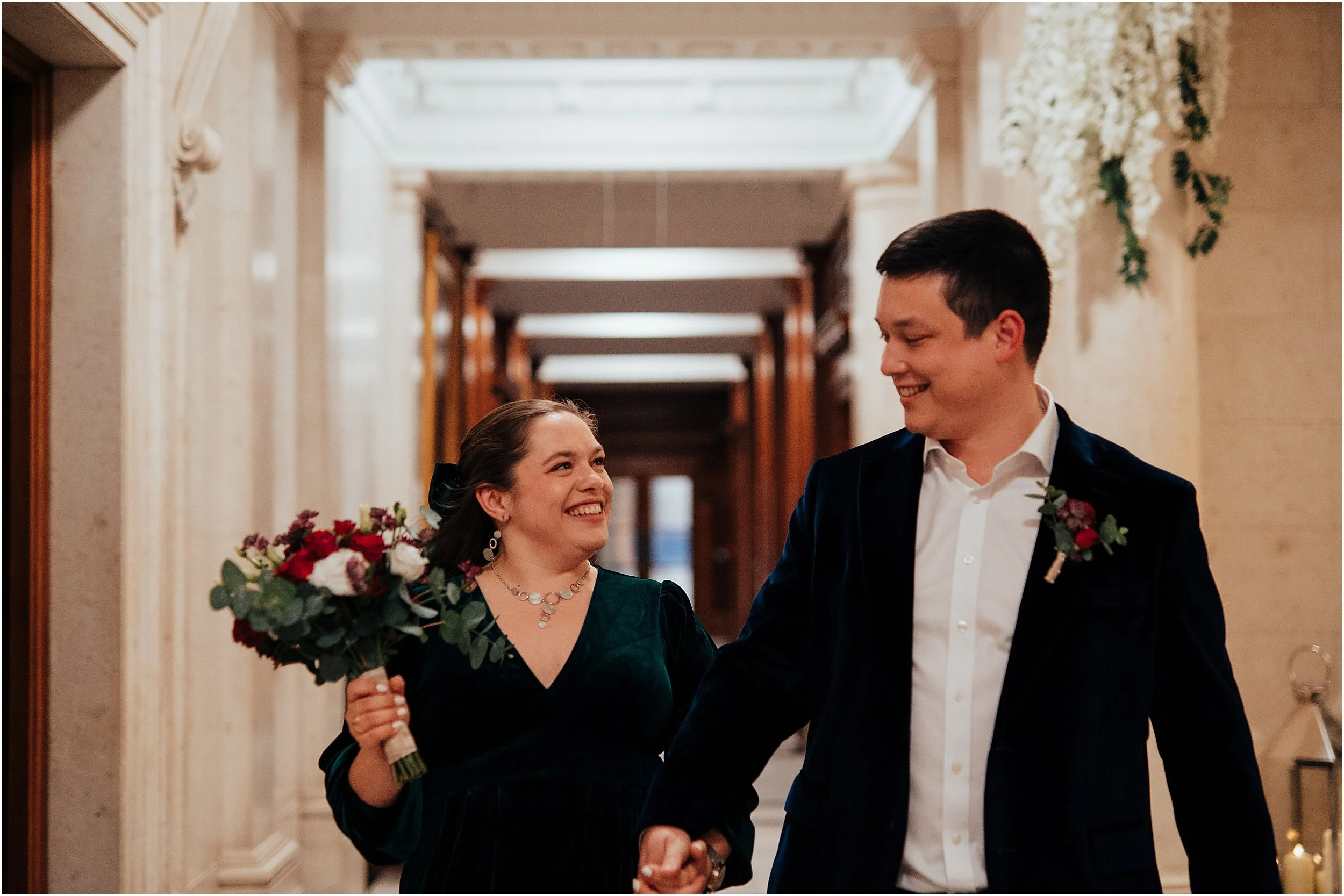 Newlyweds walking down hallway