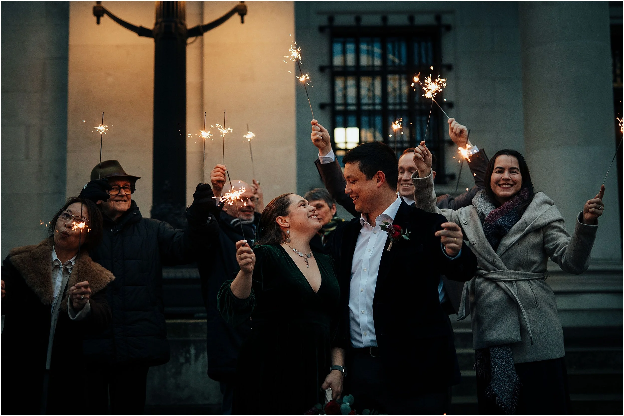 Sparkler photo with newlywed couples and wedding guests in wintery London