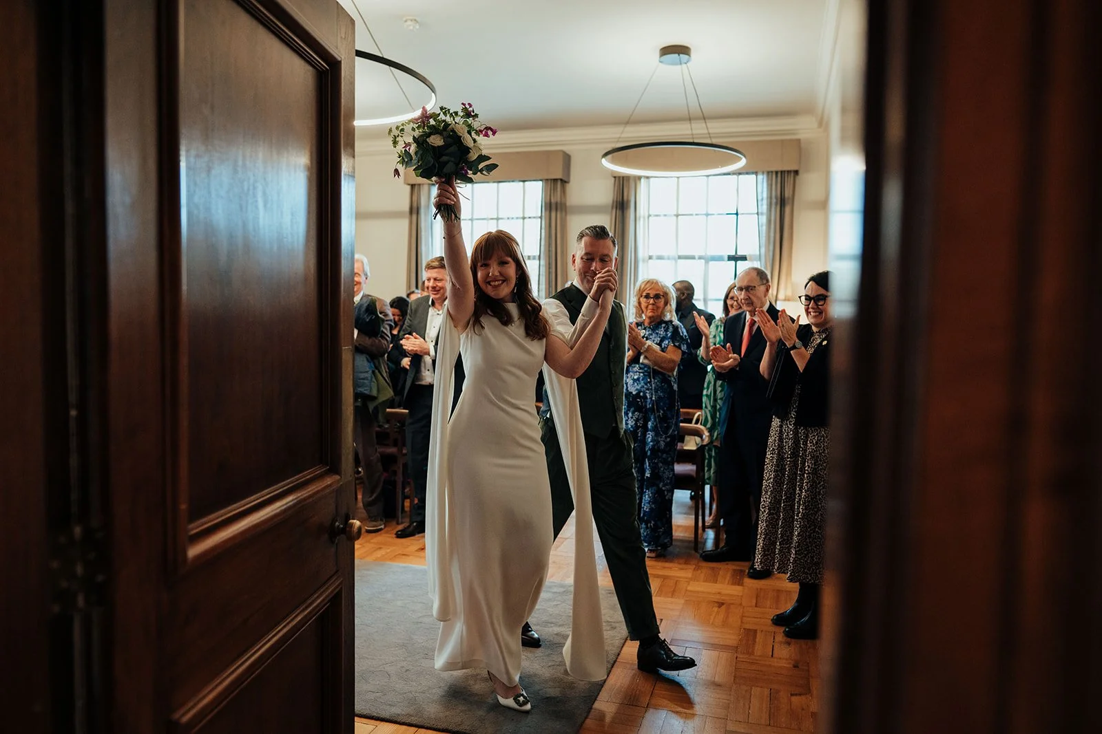 Newlywed couple exiting Mayfair Room