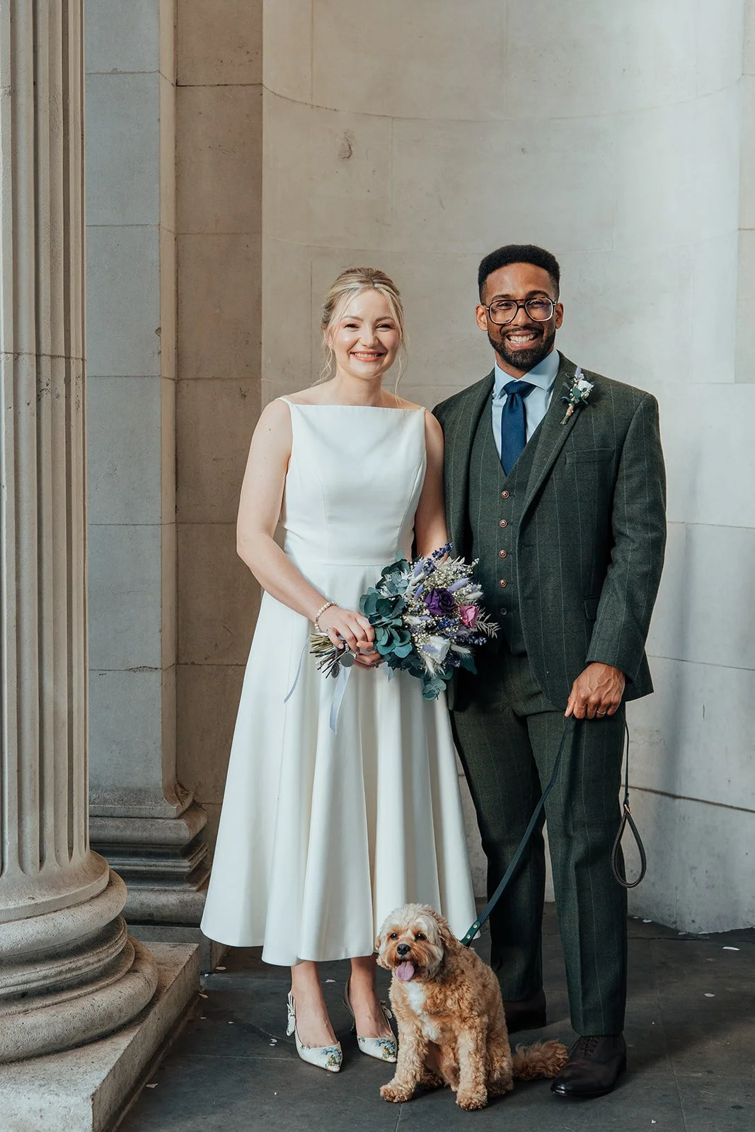 Newlyweds with their dog outside Old Marylebone Town Hall