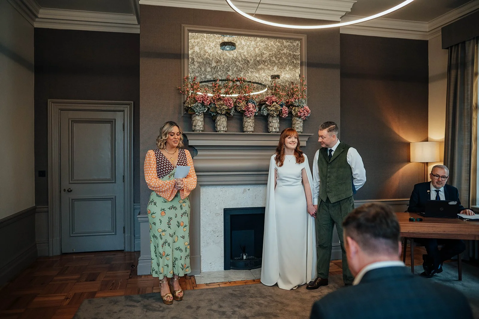 A guest reading a poem during a wedding ceremony in the Mayfair Room at Marylebone