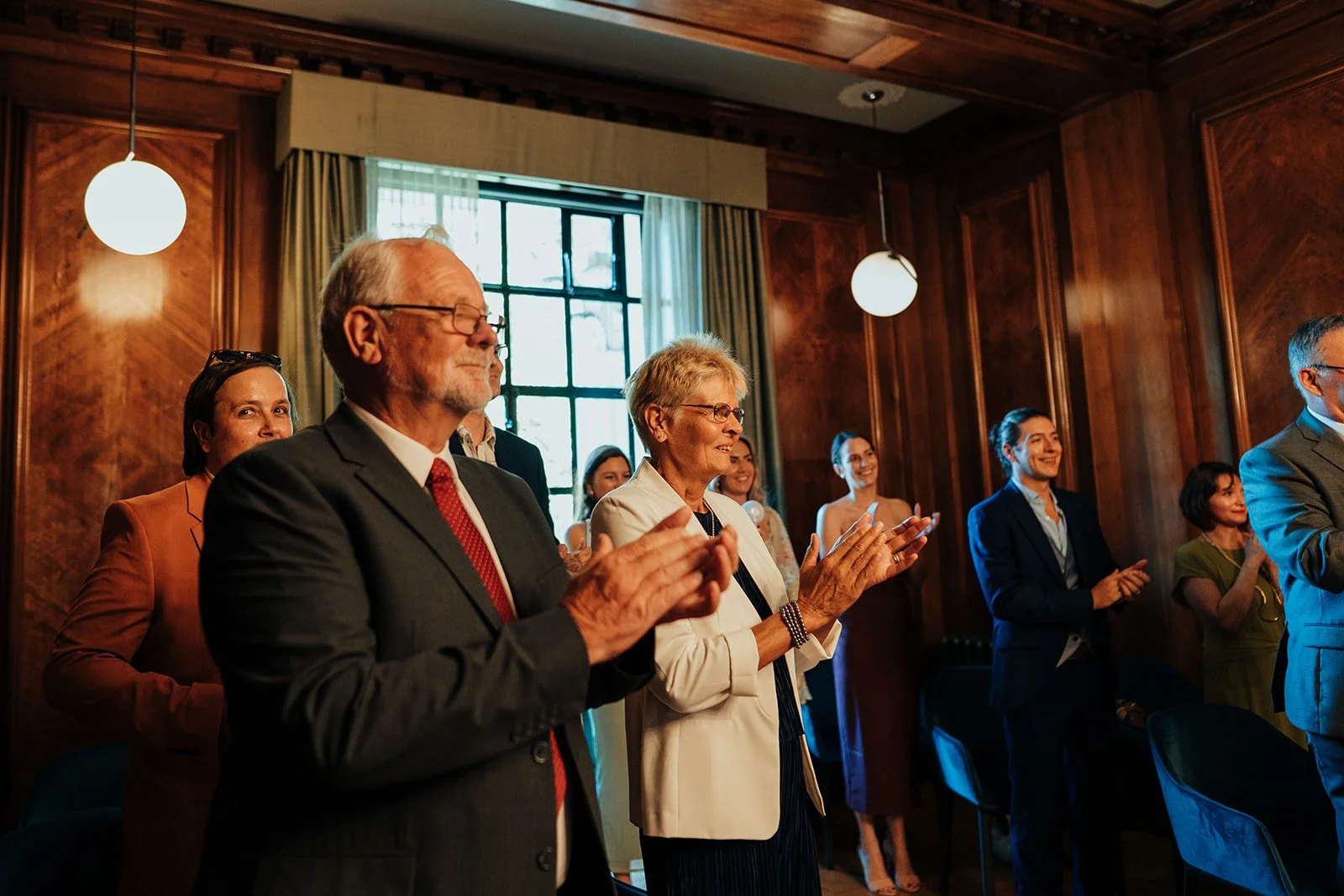 Wedding guests applauding during ceremony