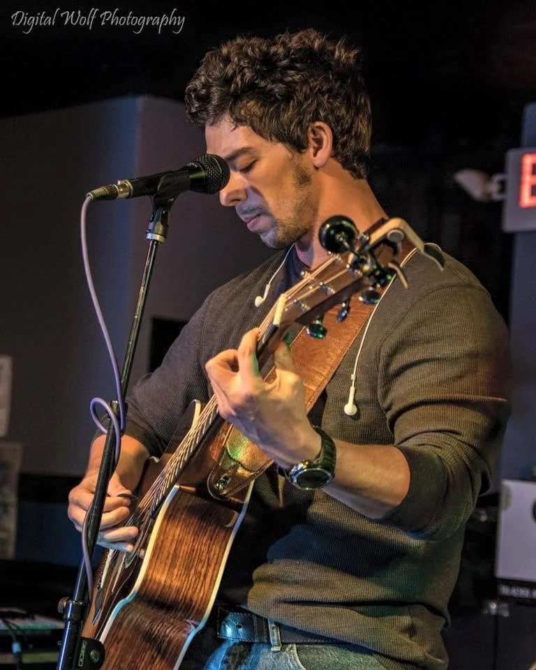 Sean Guerrero performing live on acoustic guitar and vocals